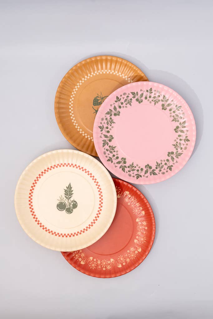 Four decorative plates with different patterns on a light gray background