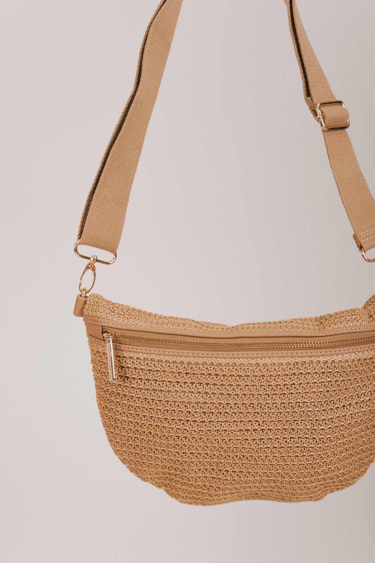 beige woven bag with adjustable strap