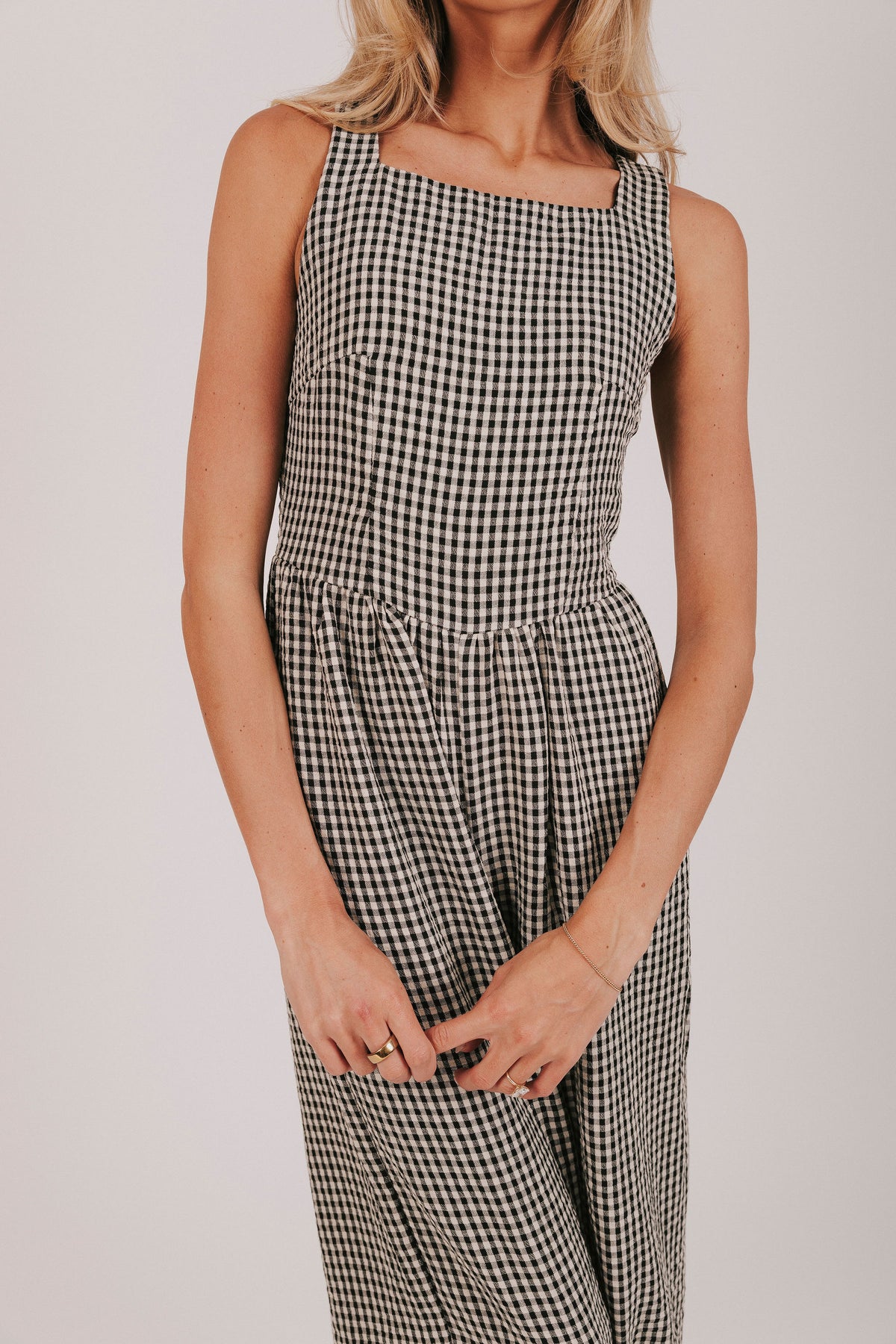 Black wide leg gingham jumpsuit with open back and tied bows