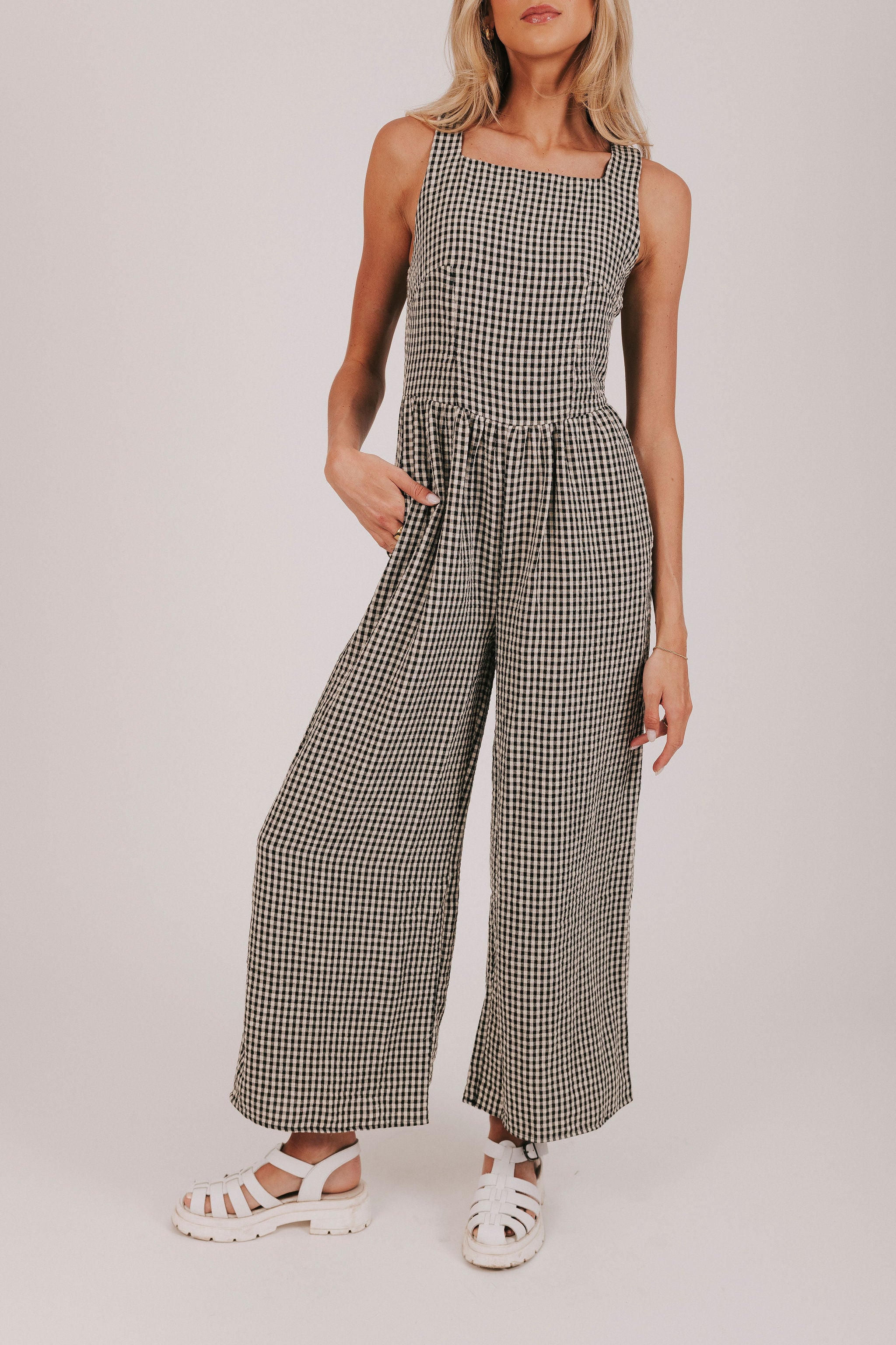 Black wide leg gingham jumpsuit with open back and tied bows
