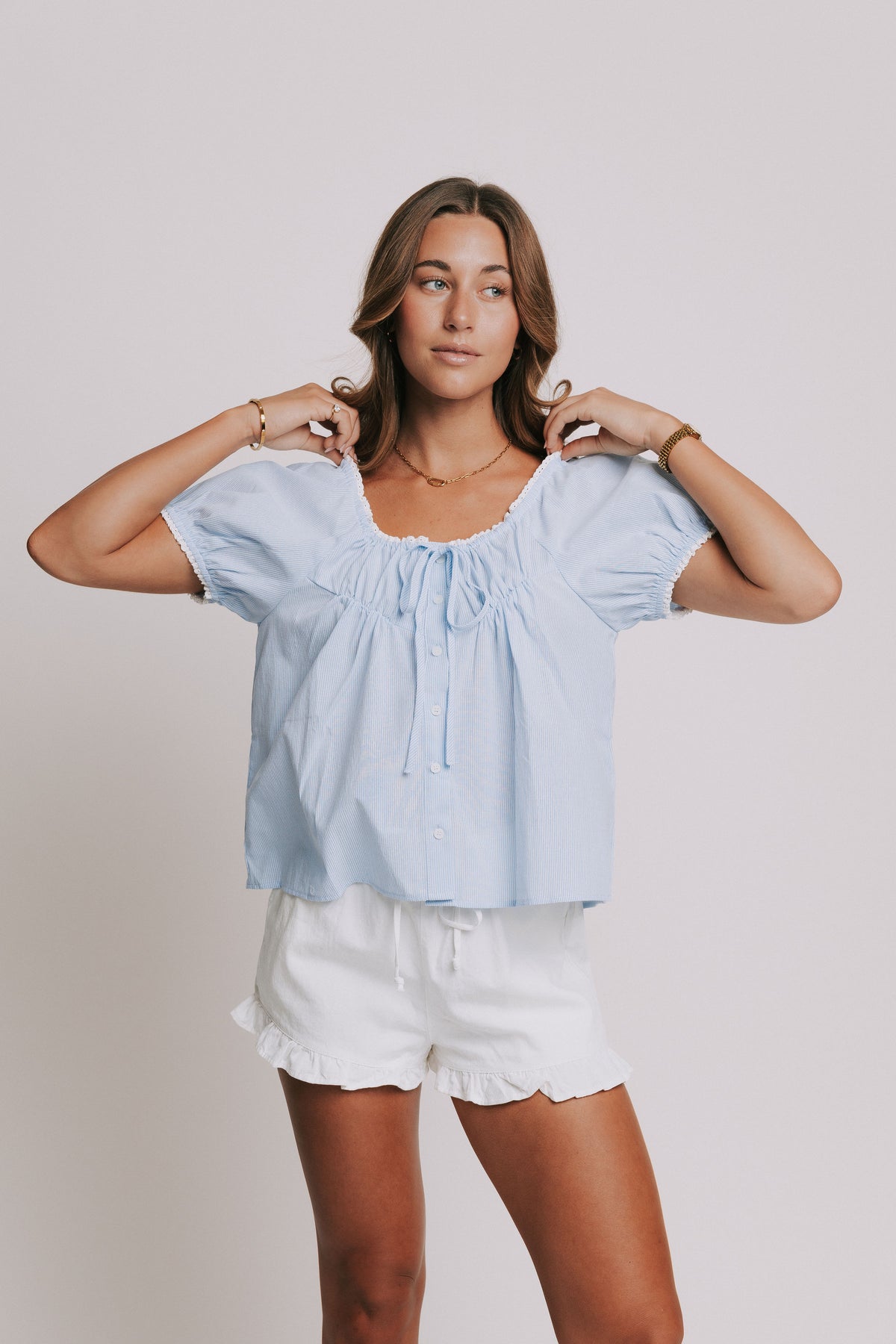 blue and white striped puff sleeve top with eyelet trim