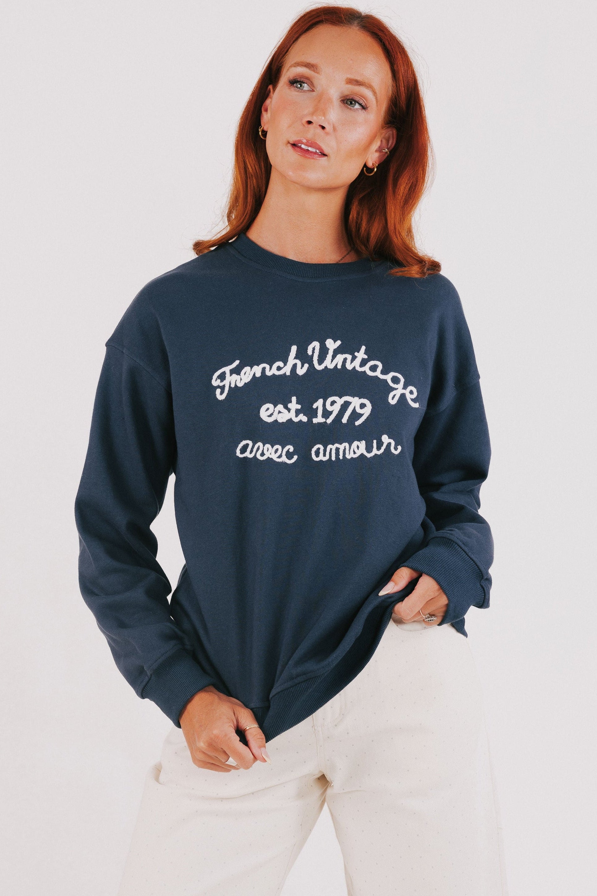 blue sweatshirt with white embroidered words