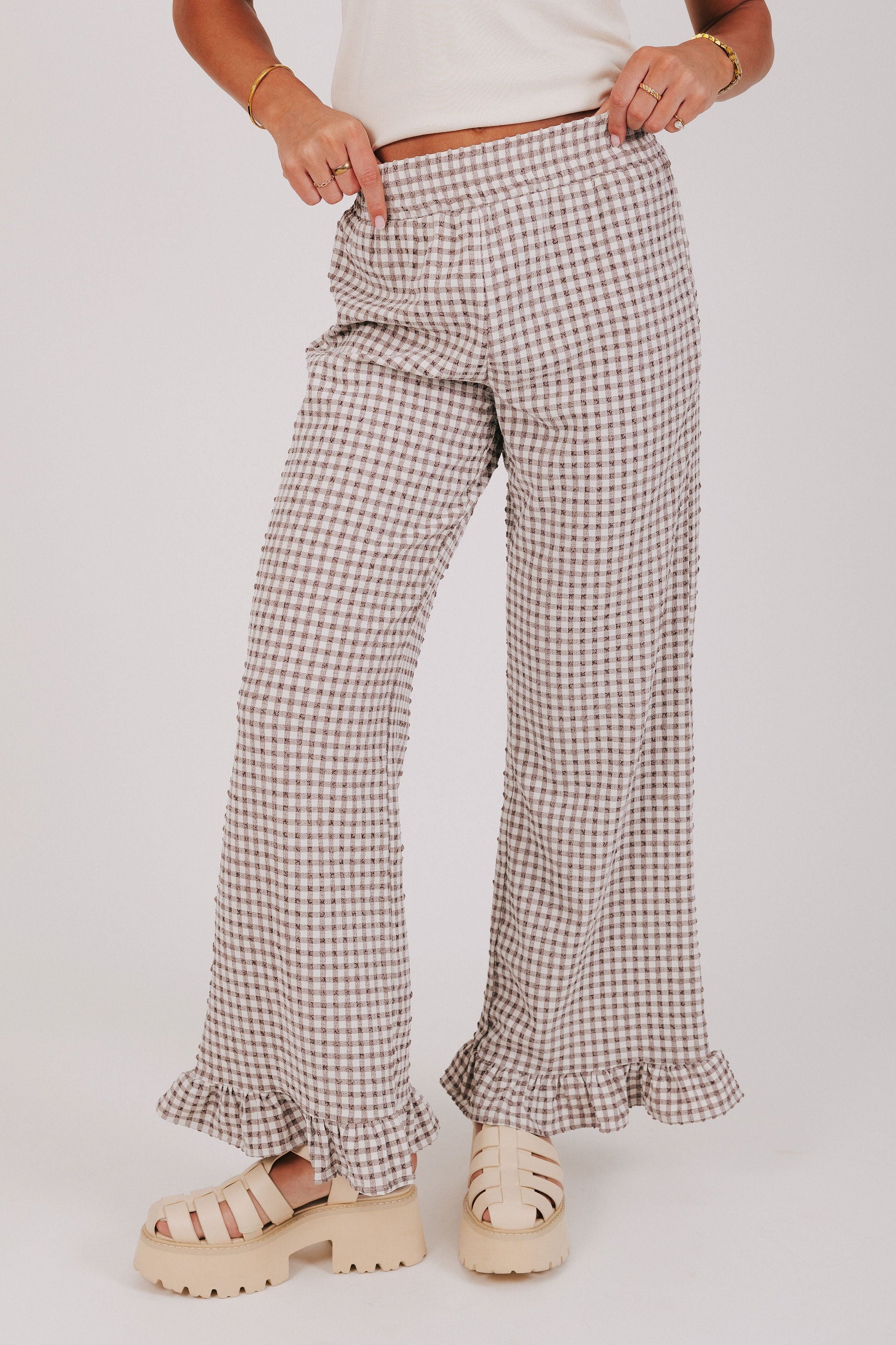 brown and white gingham pants with ruffled cuffs