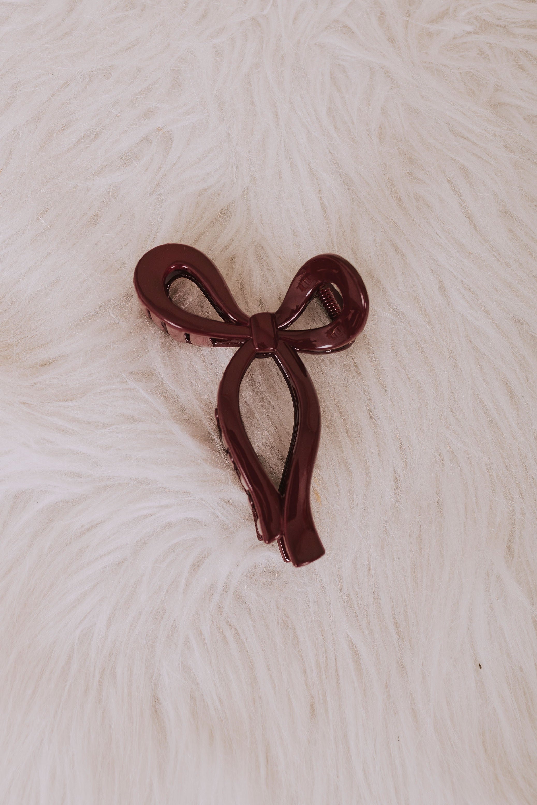 burgundy plastic bow hair clip flatlay
