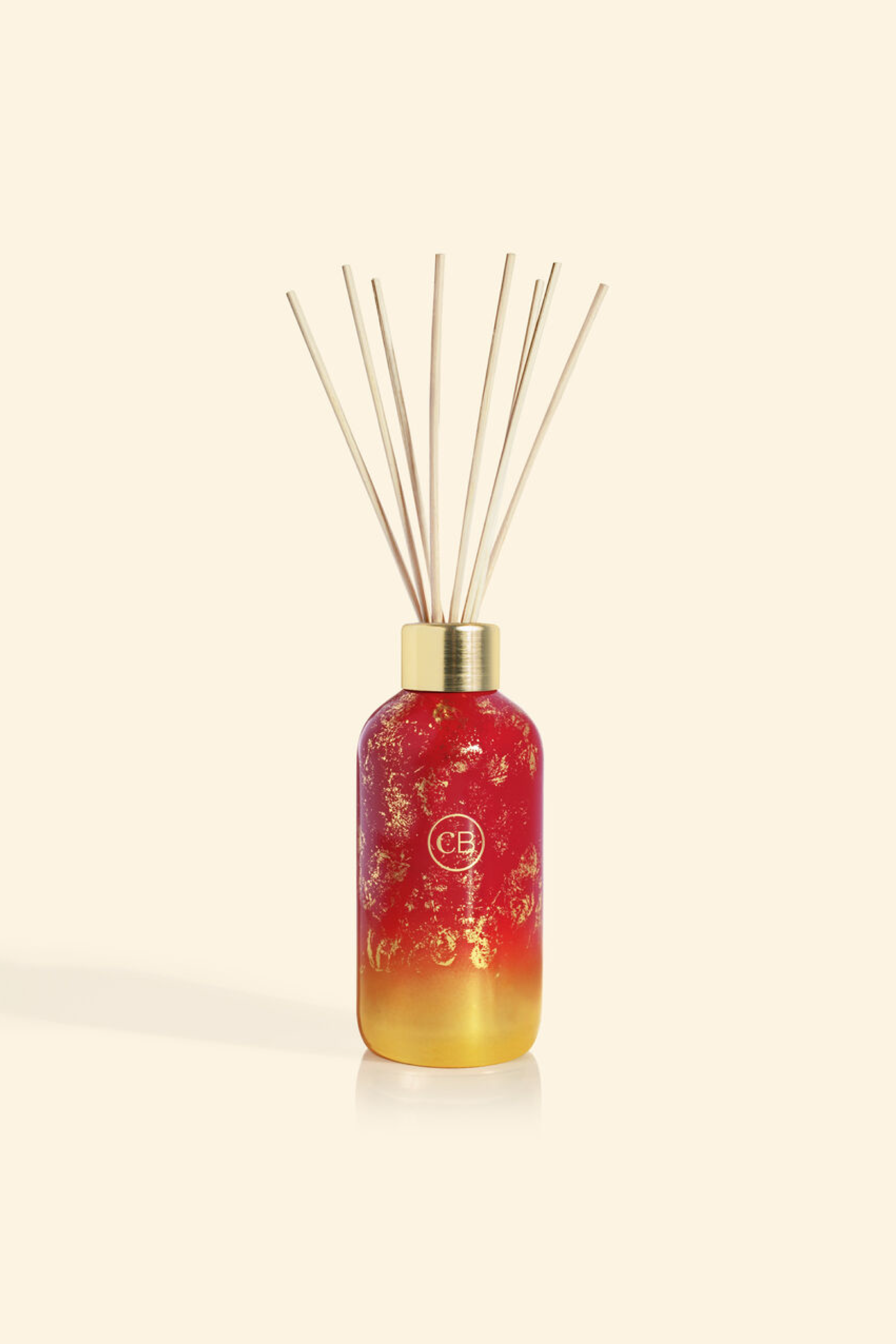 Red and gold ombre diffuser bottle with reeds