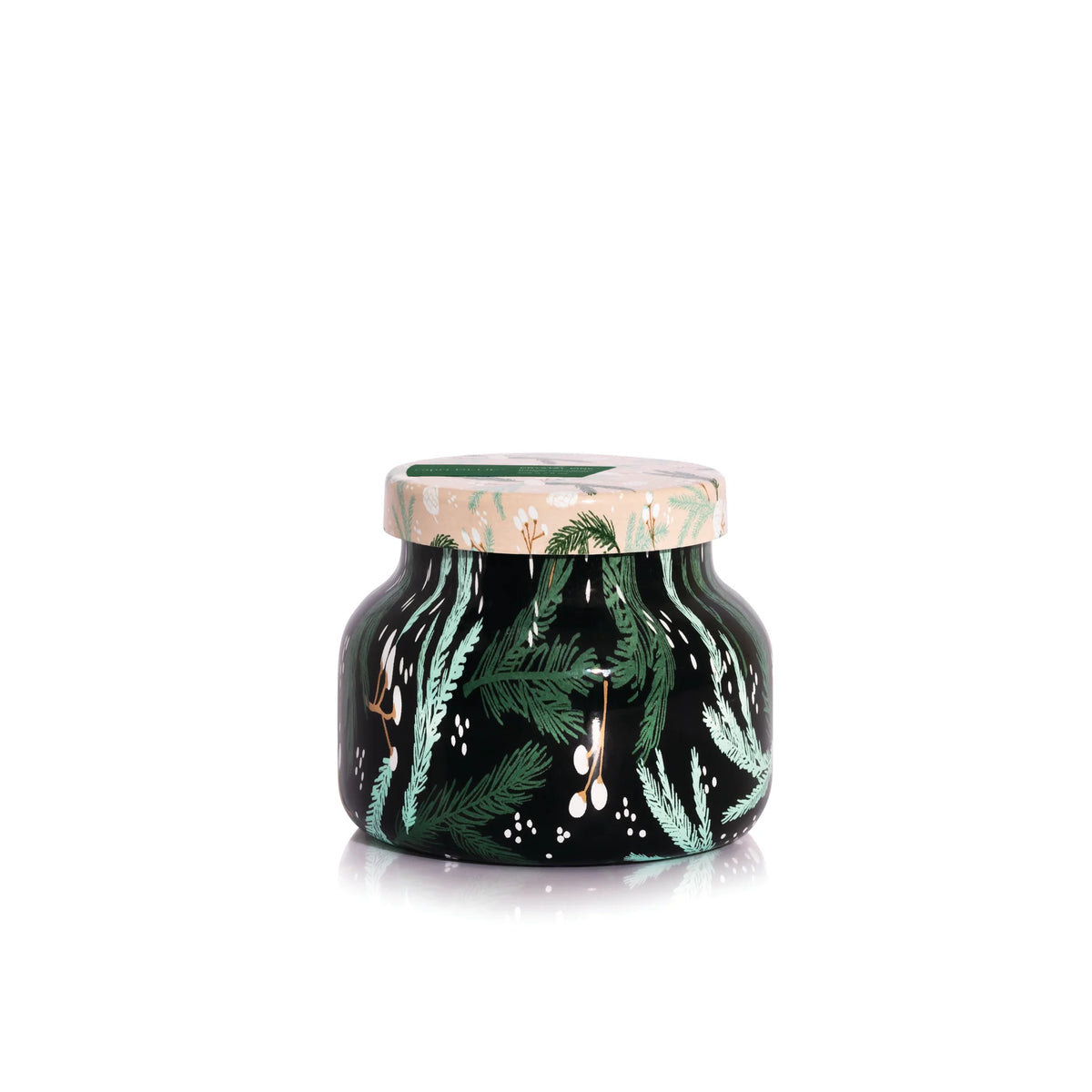 Decorative candle jar with green tree sprig pattern in scent crystal pine by capri blue.