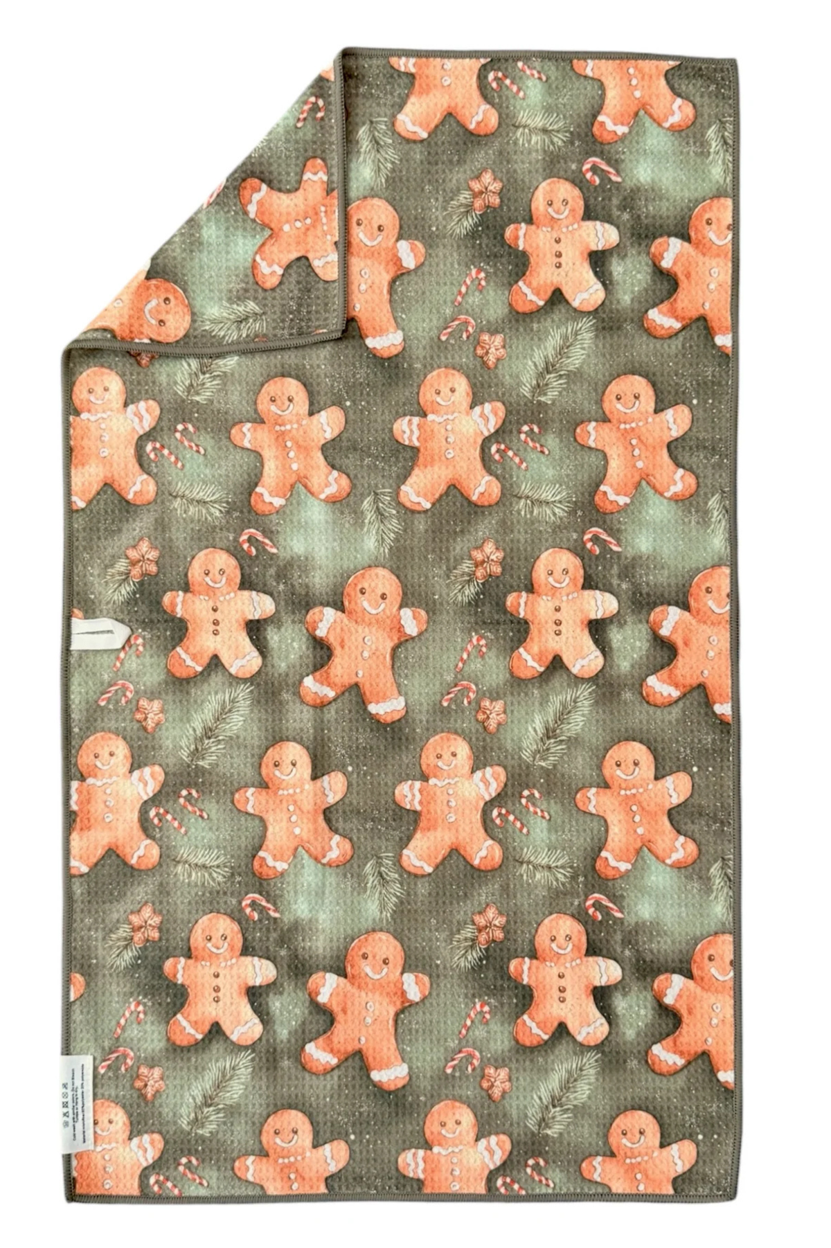 Microfiber hand towel with gingerbread man pattern on a green background.
