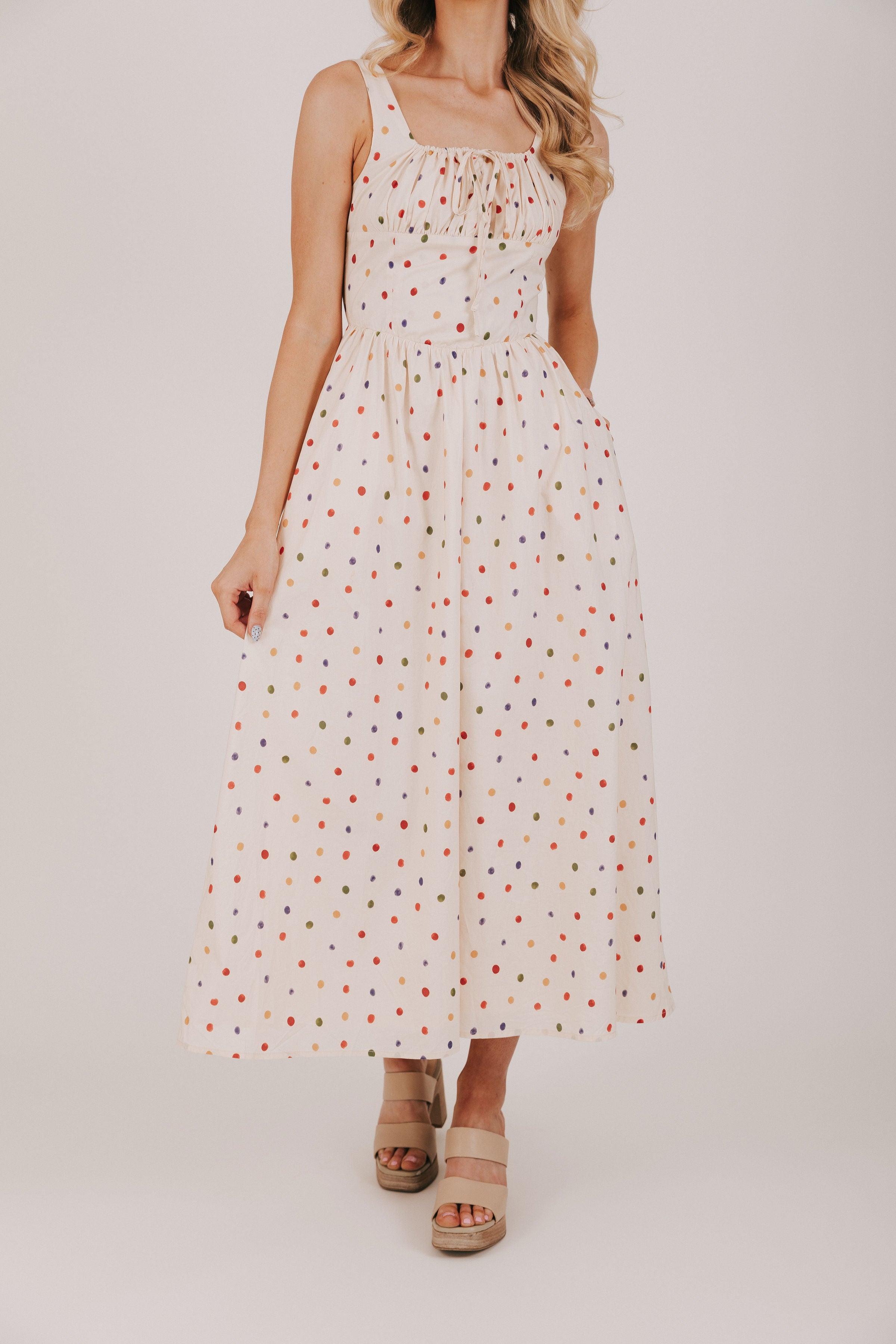 cream dress with multicolored polka dots