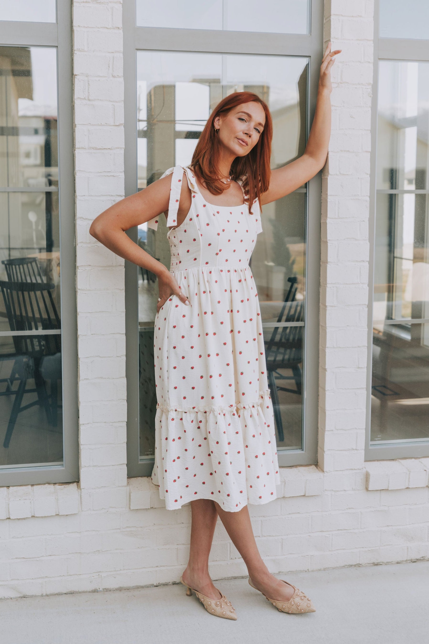 cream midi dress with strawberry print and bows on shoulders