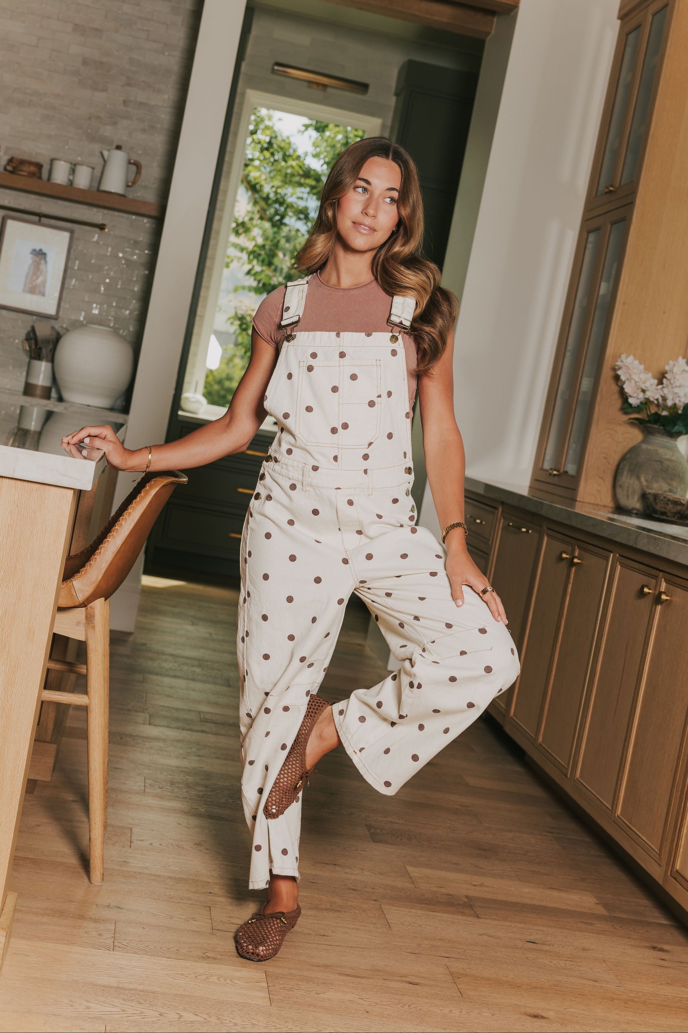 cream overalls with brown polka dots lifestyle