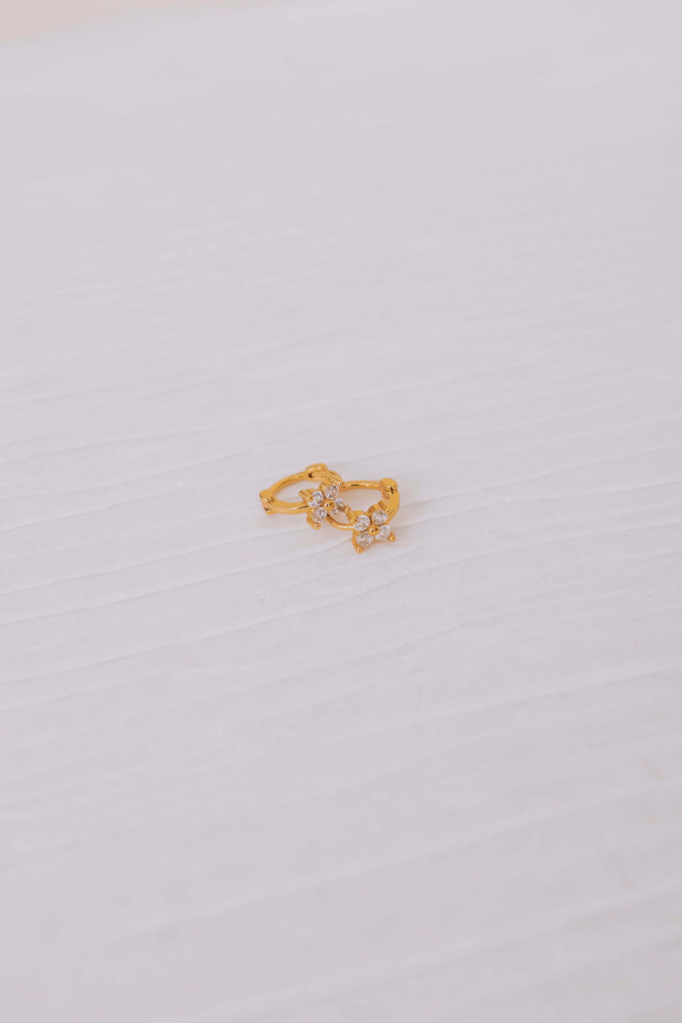 cubic zirconia floral huggie earrings flatlay