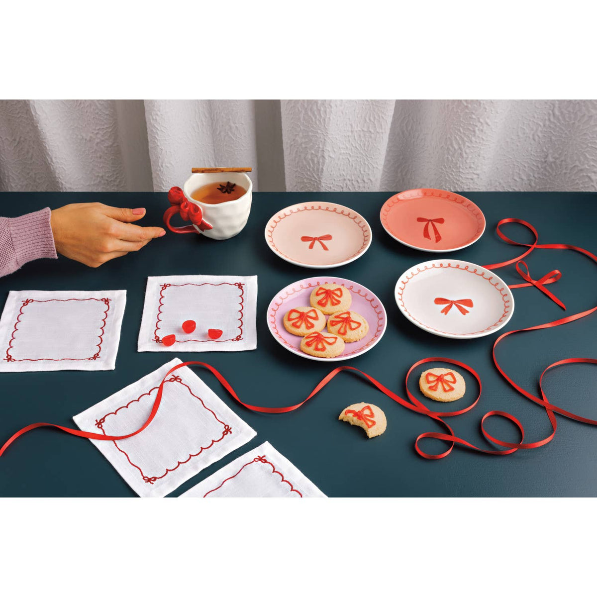 Set of 4 appetizer plates with bow details and red trim in peach and pink colors