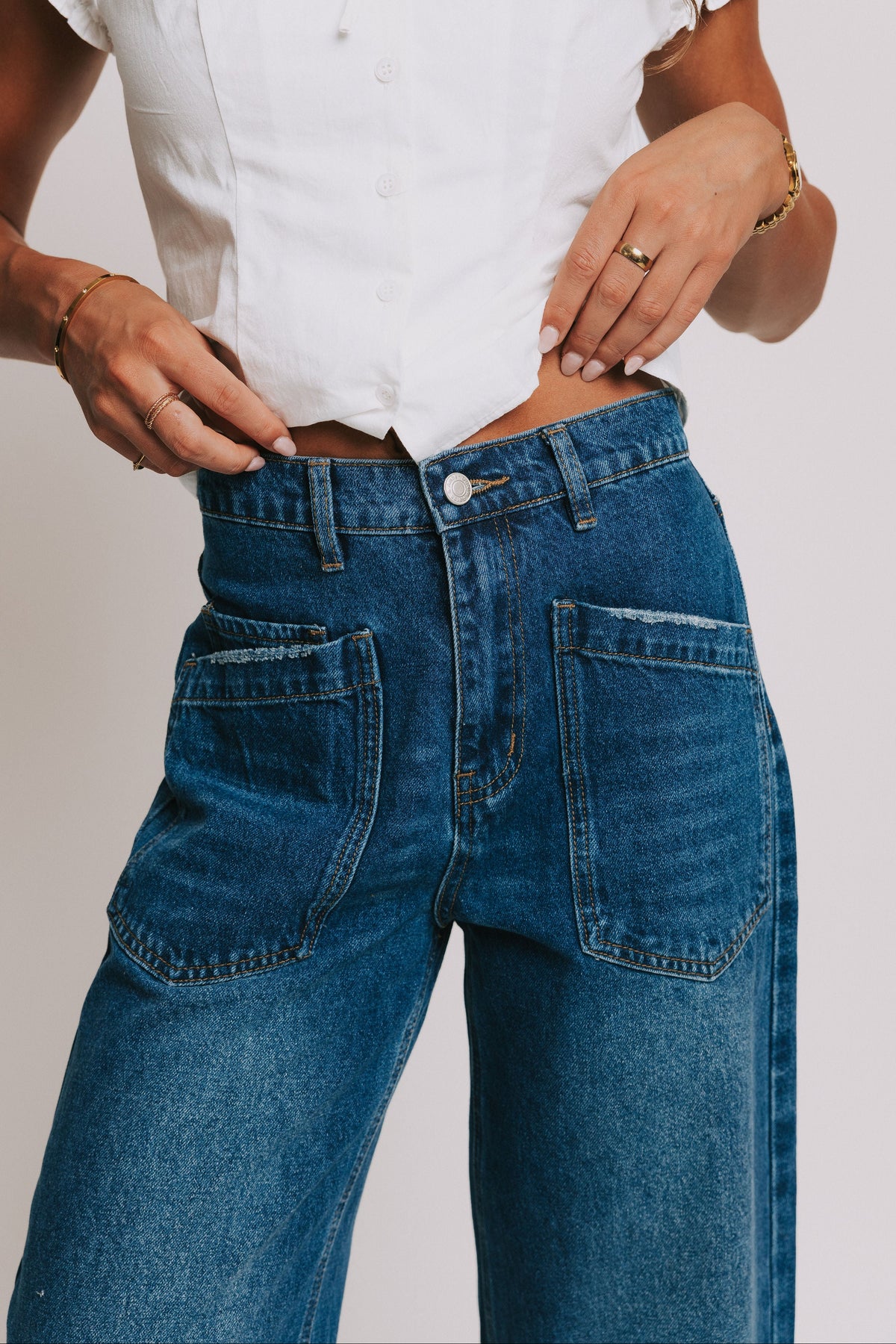 dark wash denim jeans with oversized front pockets close