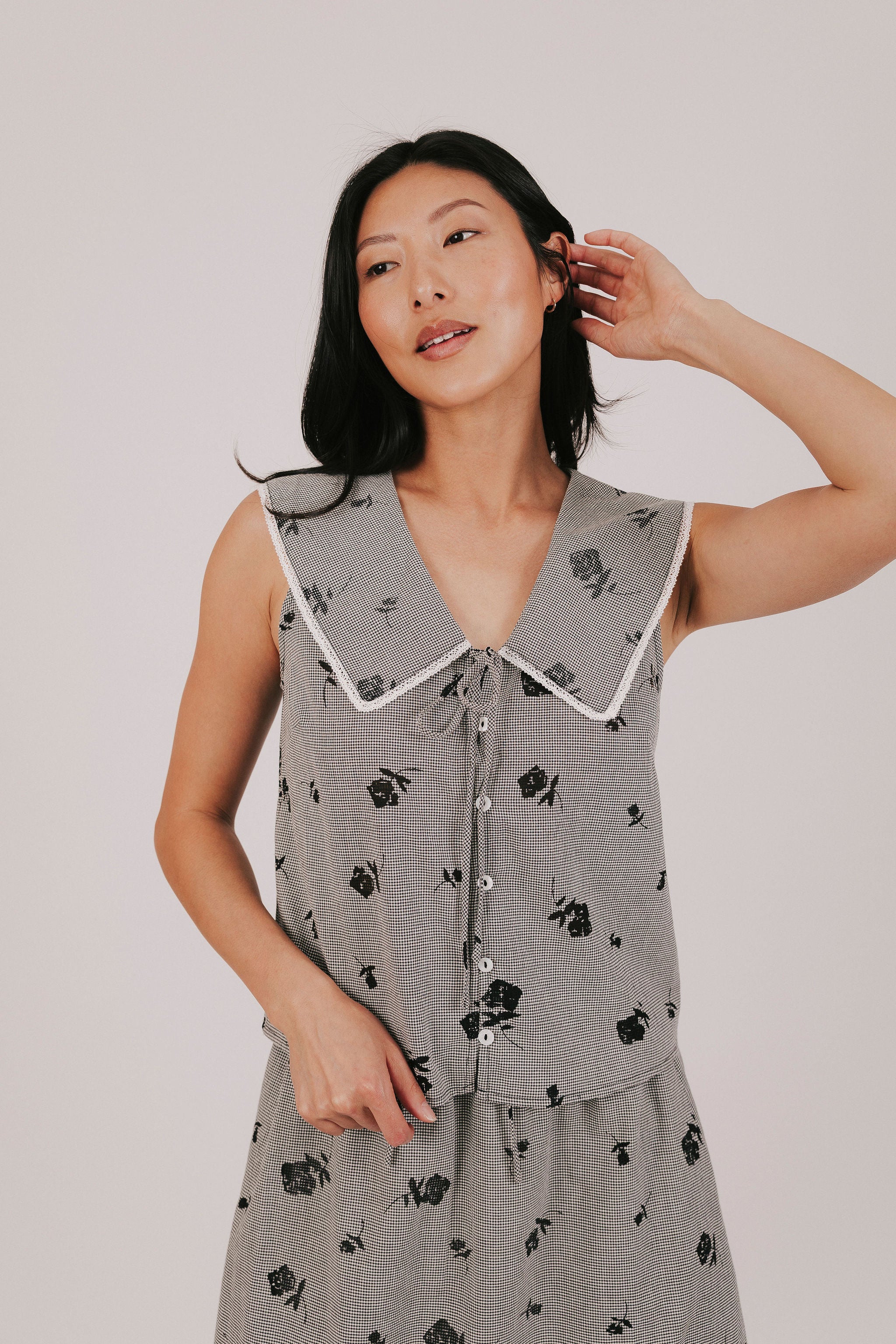 gingham sleeveless top with sheer black flowers and buttons down the front