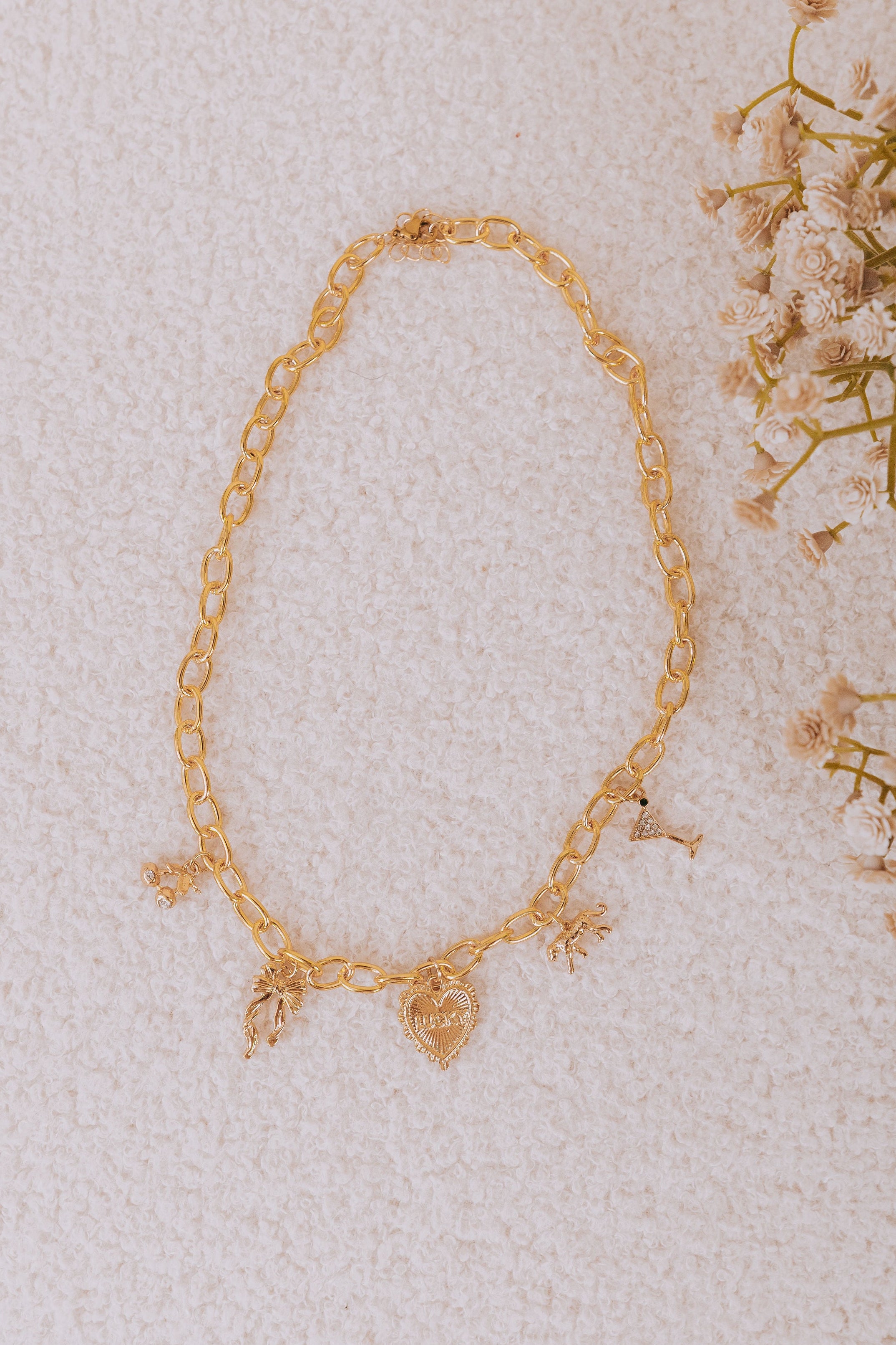 Gold chain charm necklace with cherry, heart, bow, cat, and martini charms