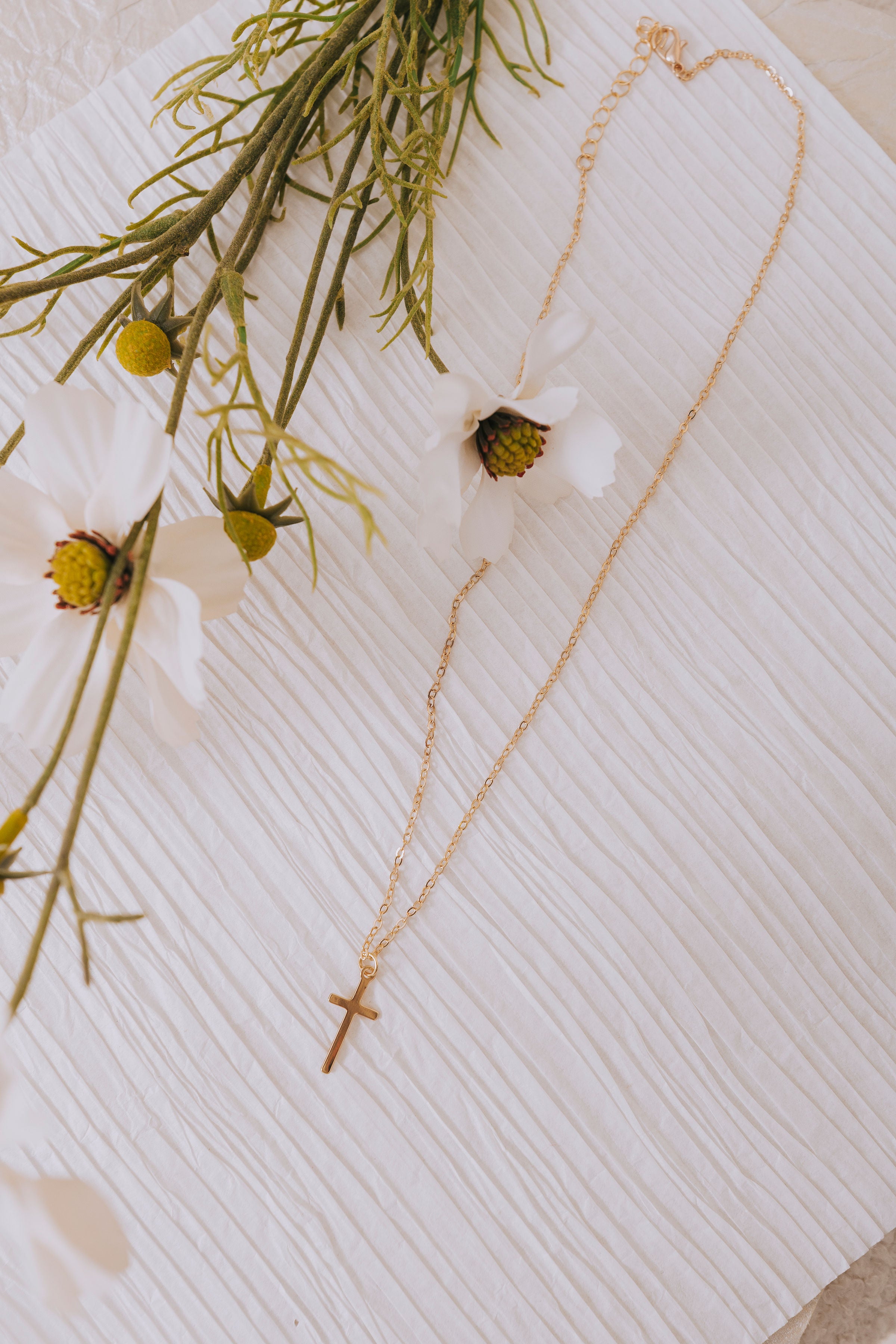 gold cross pendant necklace flatlay