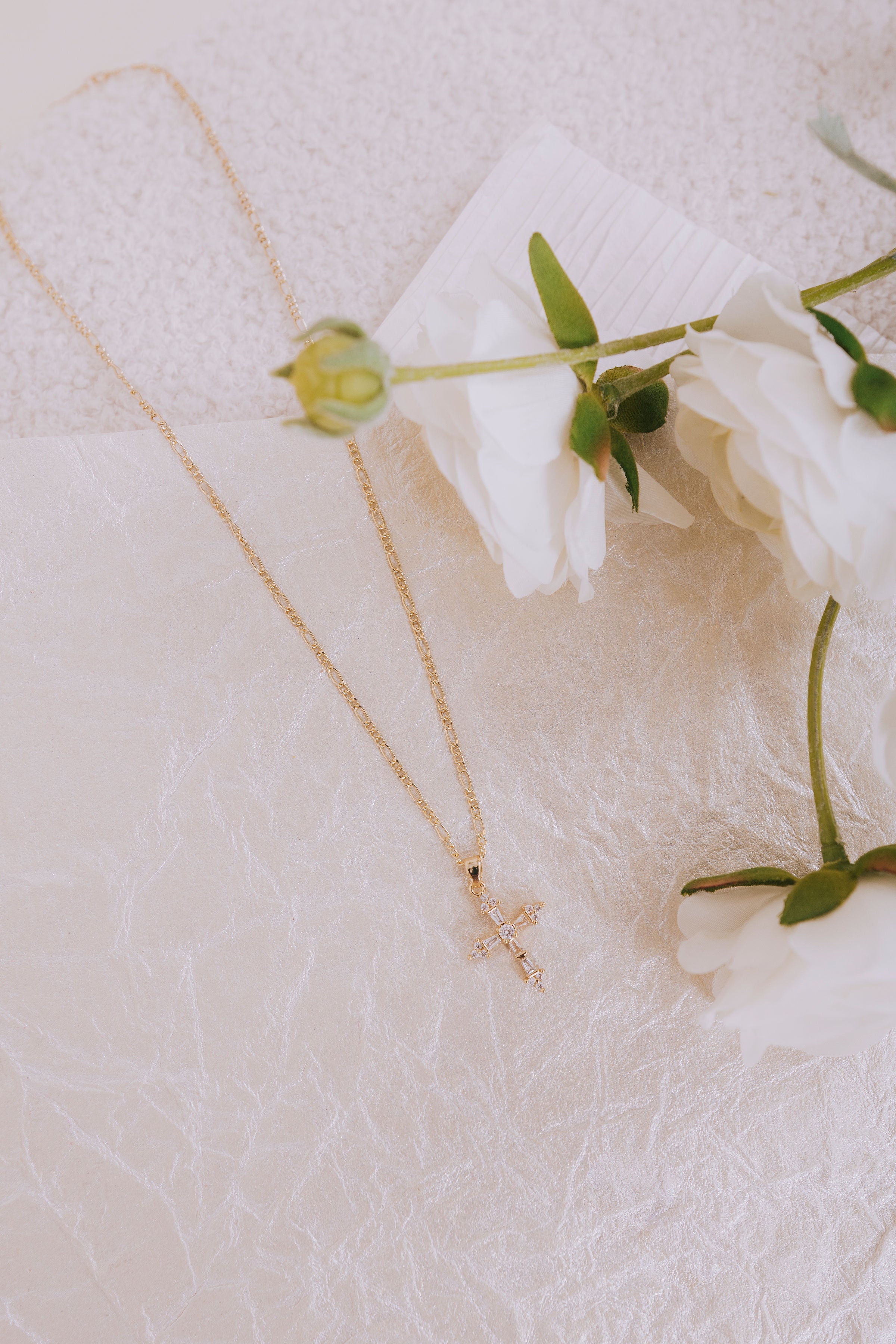 gold cross rhinestone pendant necklace flatlay