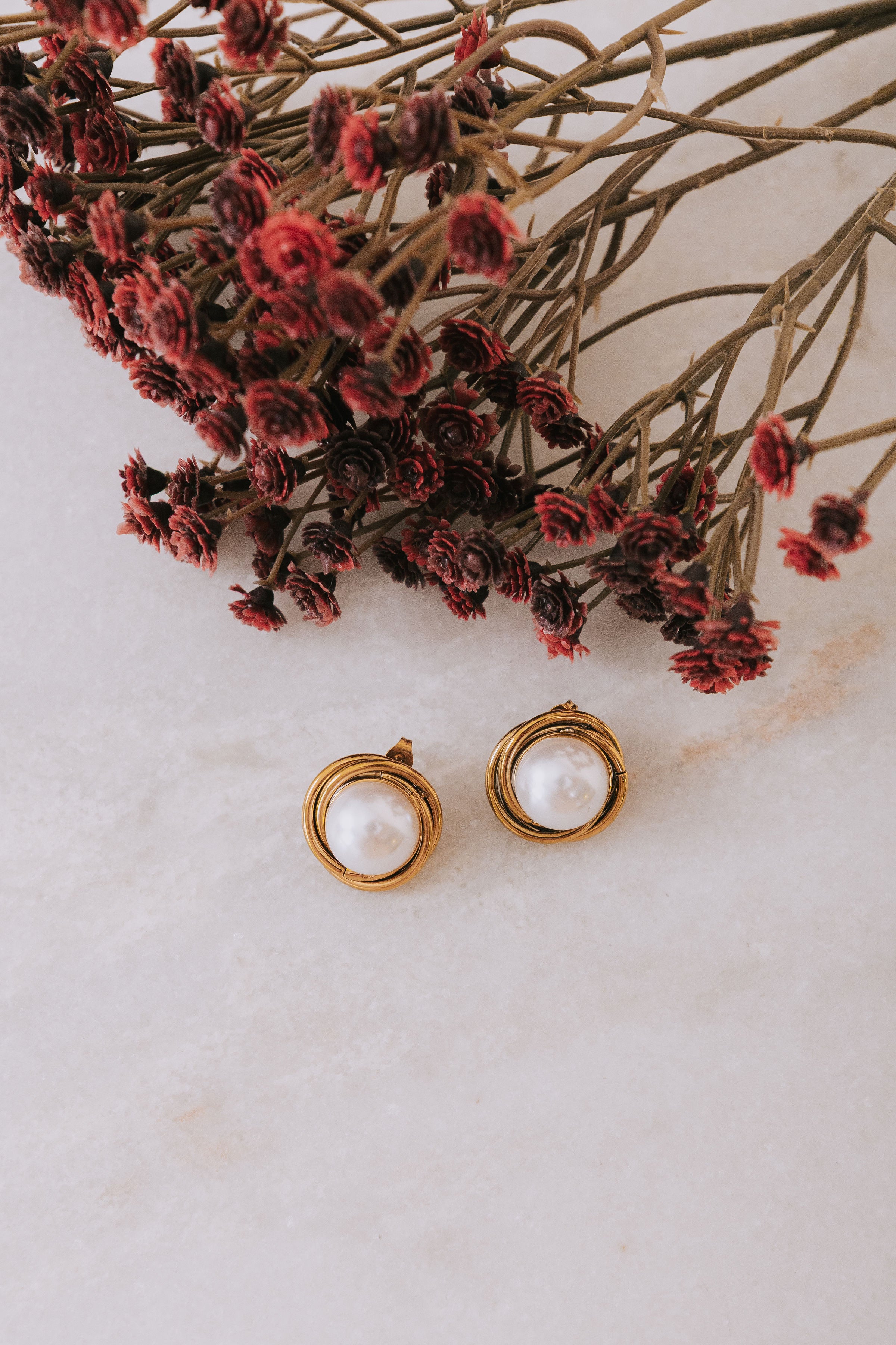 Gold colored layers earrings with large faux pearl center