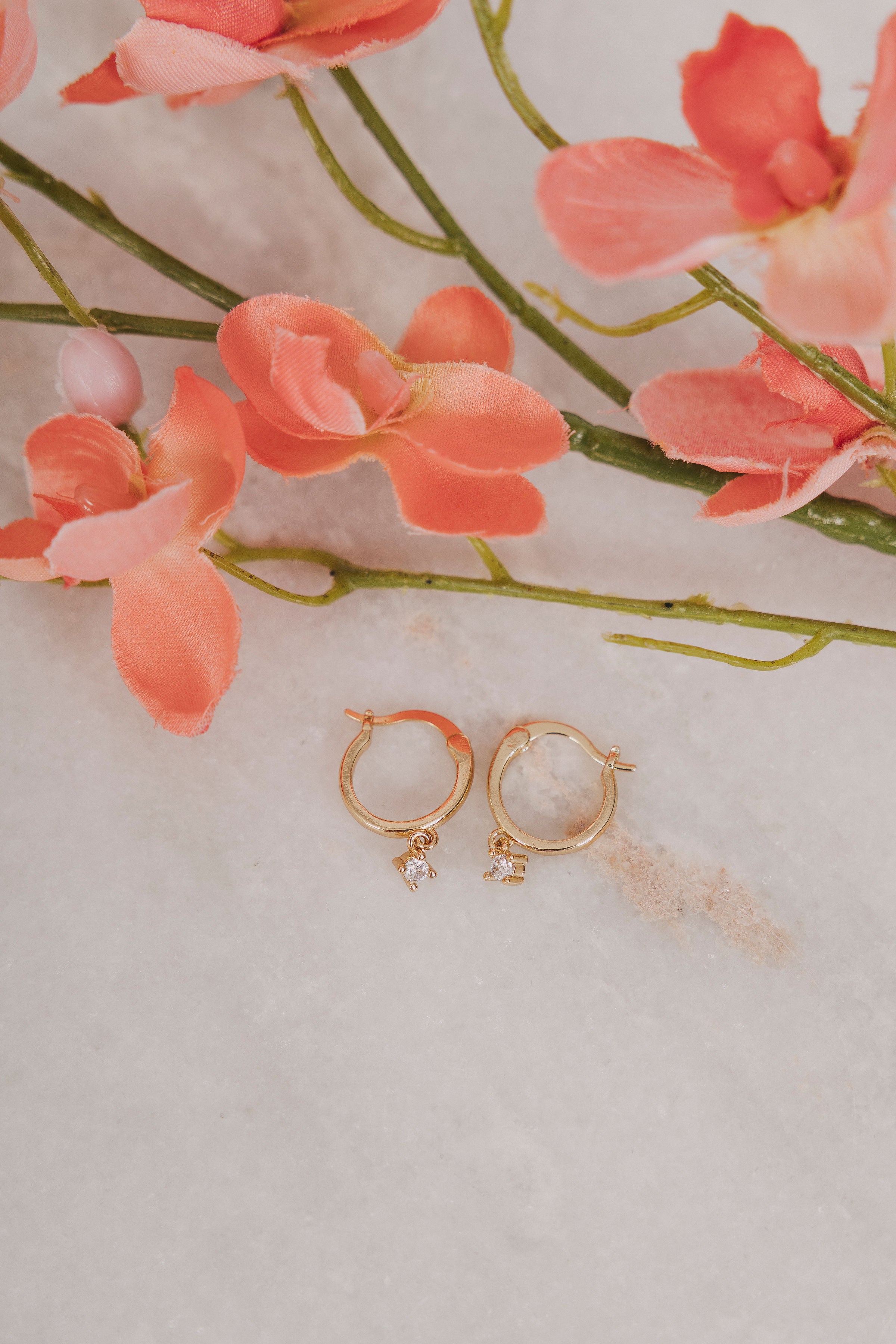 gold hoop earrings flat lay