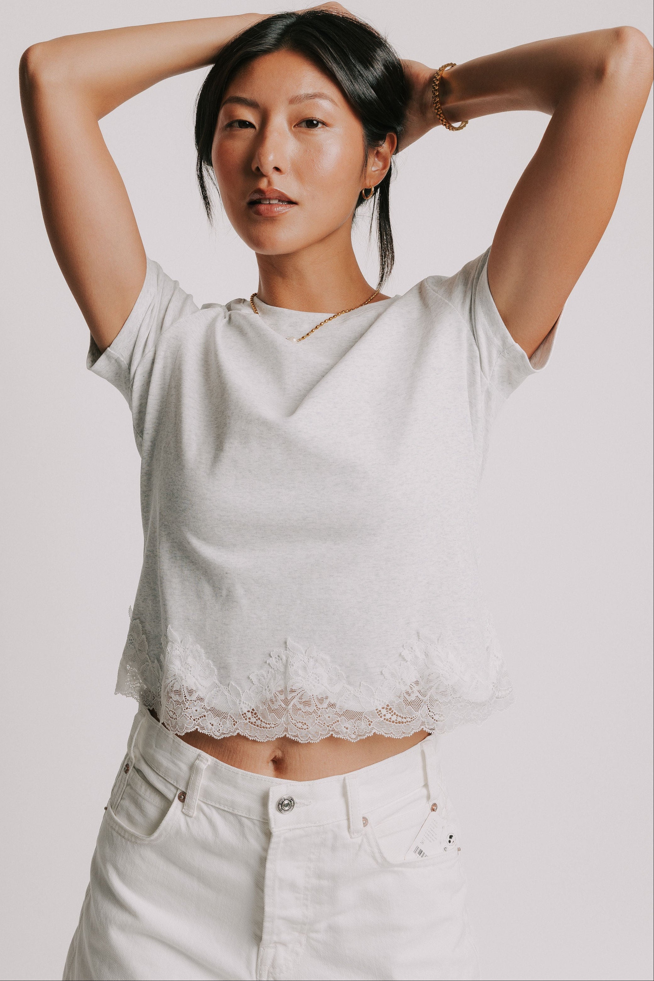 grey short sleeve top with lace trim on hem
