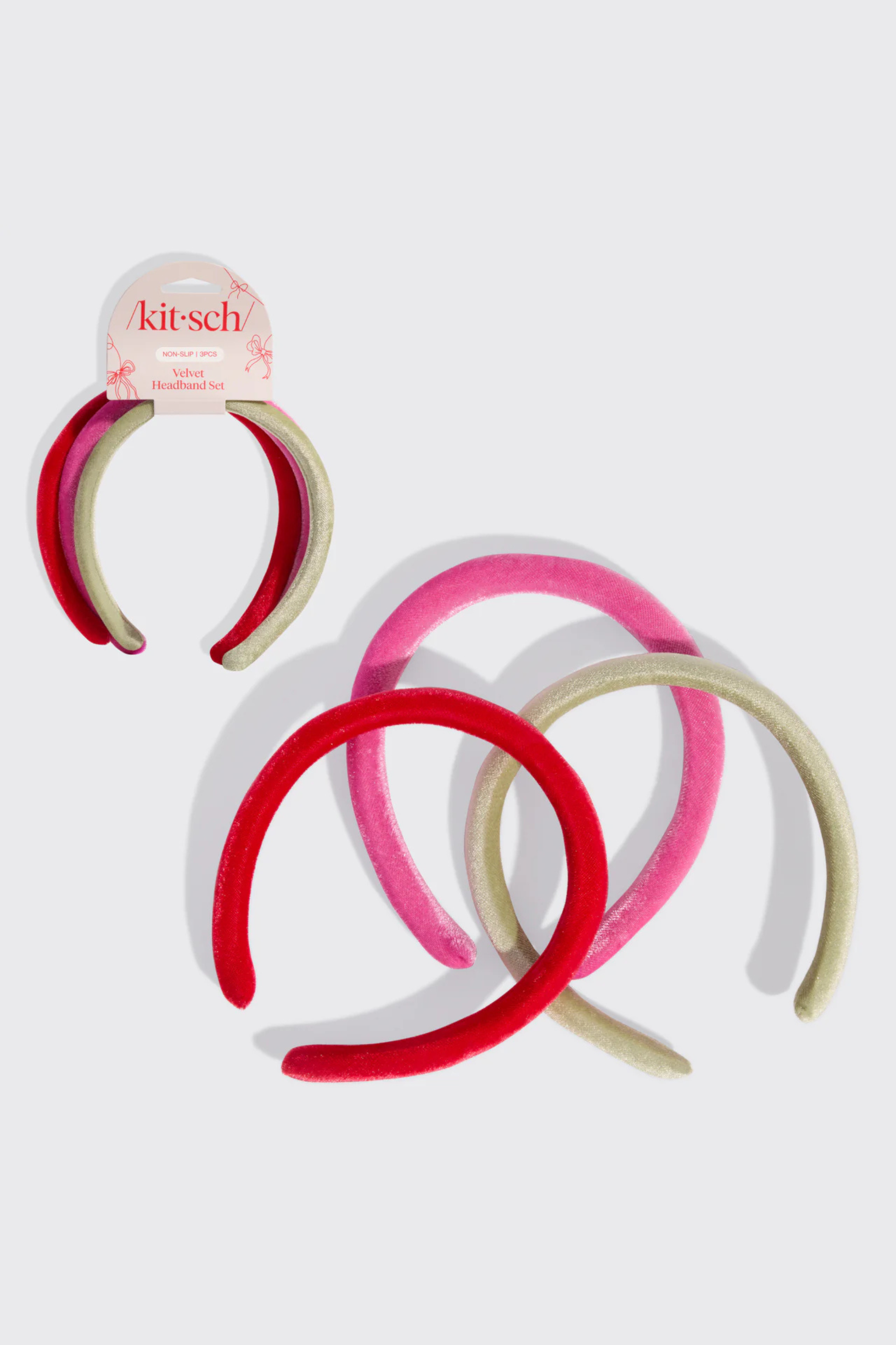 A set of velvet headbands in green, red, and pink.