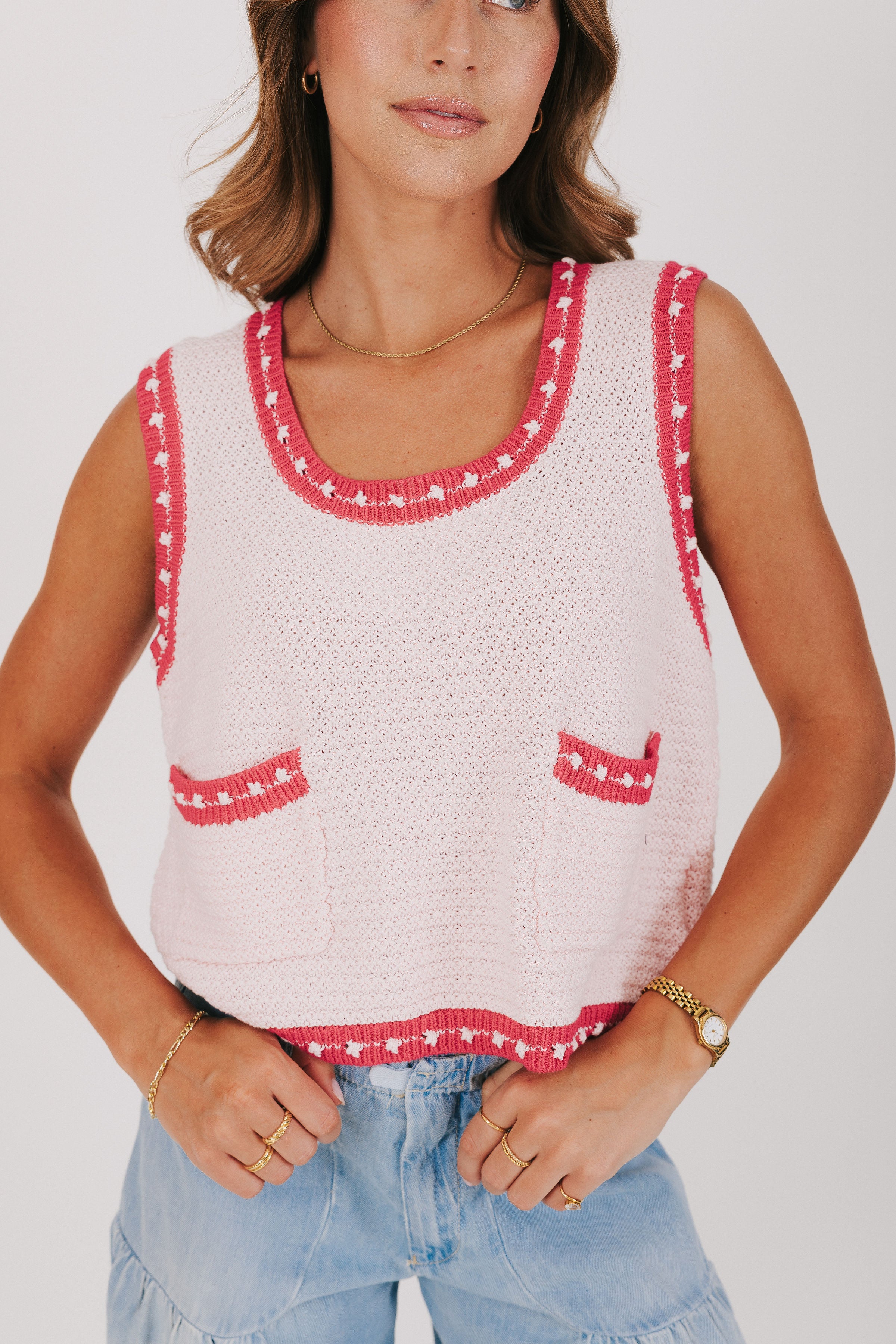light pink knit vest with dark pink trim