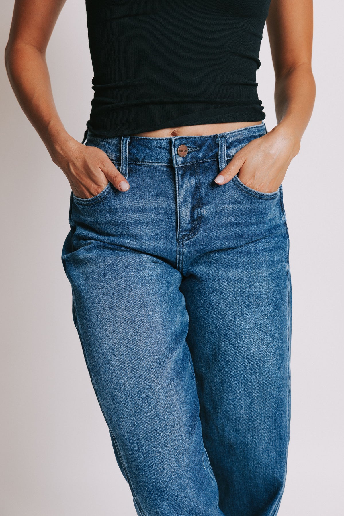 medium wash tapered leg jeans close