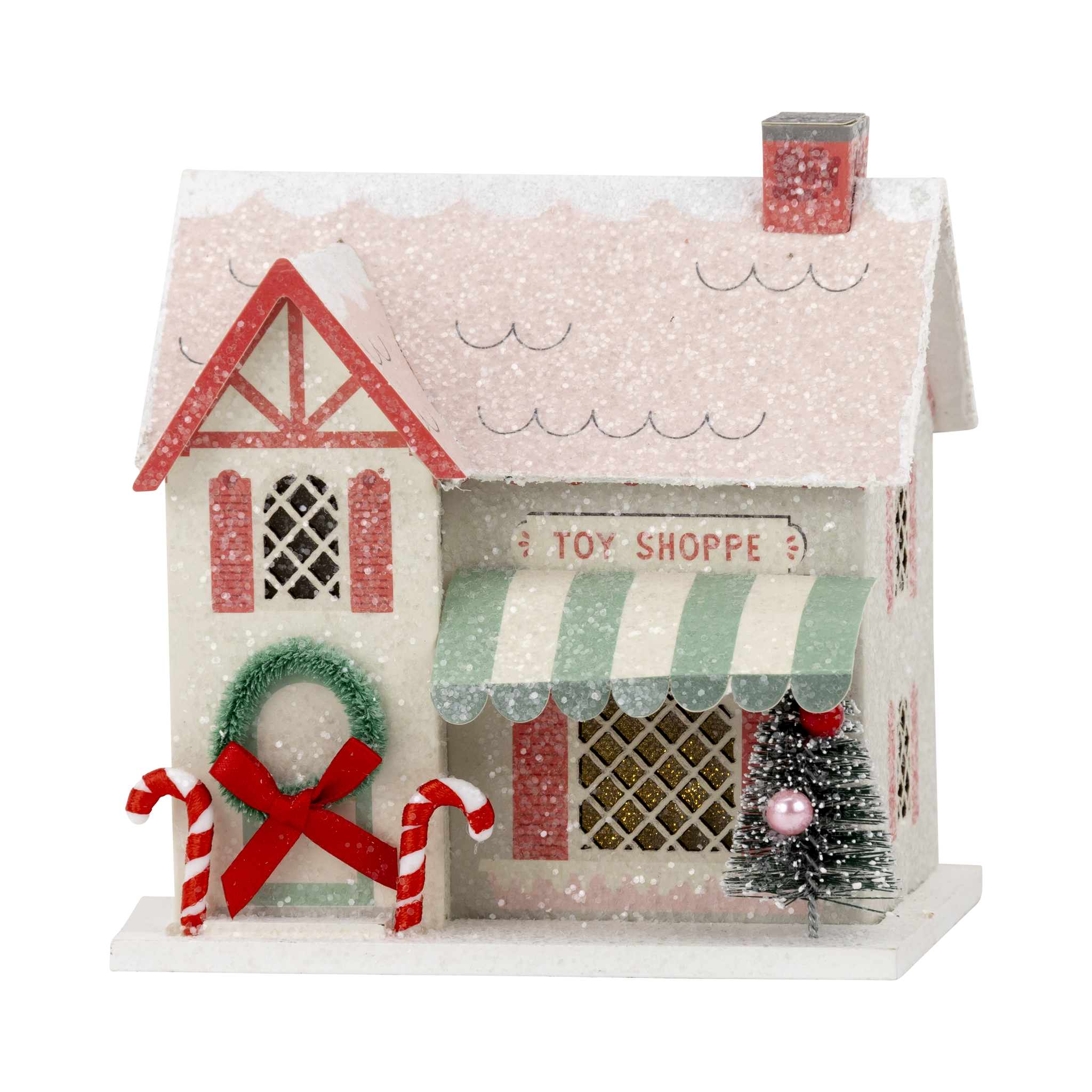 Decorative toy shoppe house with candy canes and a Christmas tree with snow like glitter.