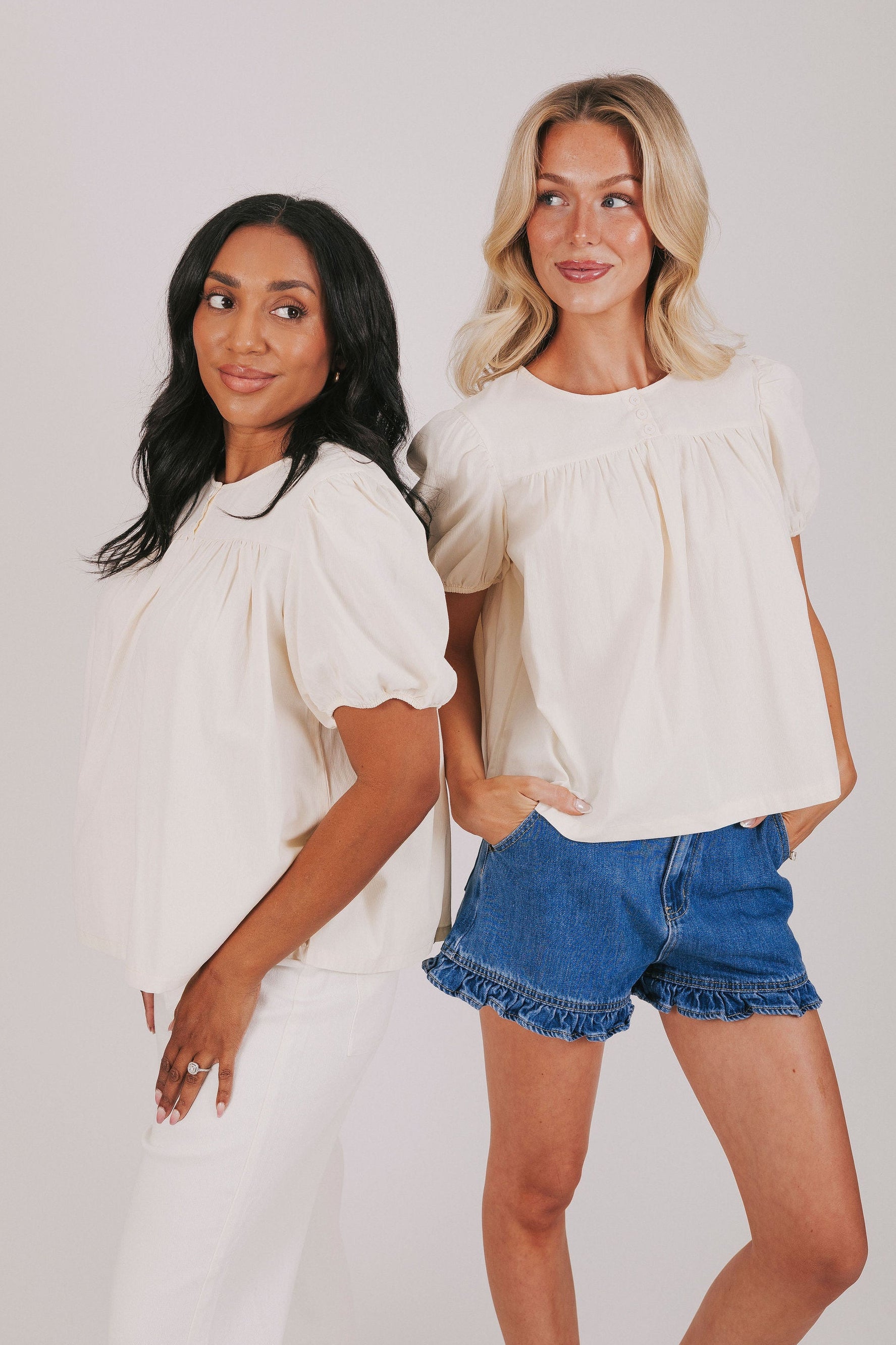 ivory colored blouse with short puff sleeves and gathered detail