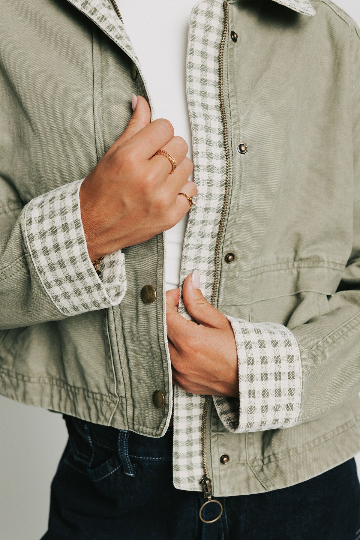 oversized green jacket with checkered print on collar and cuffs close