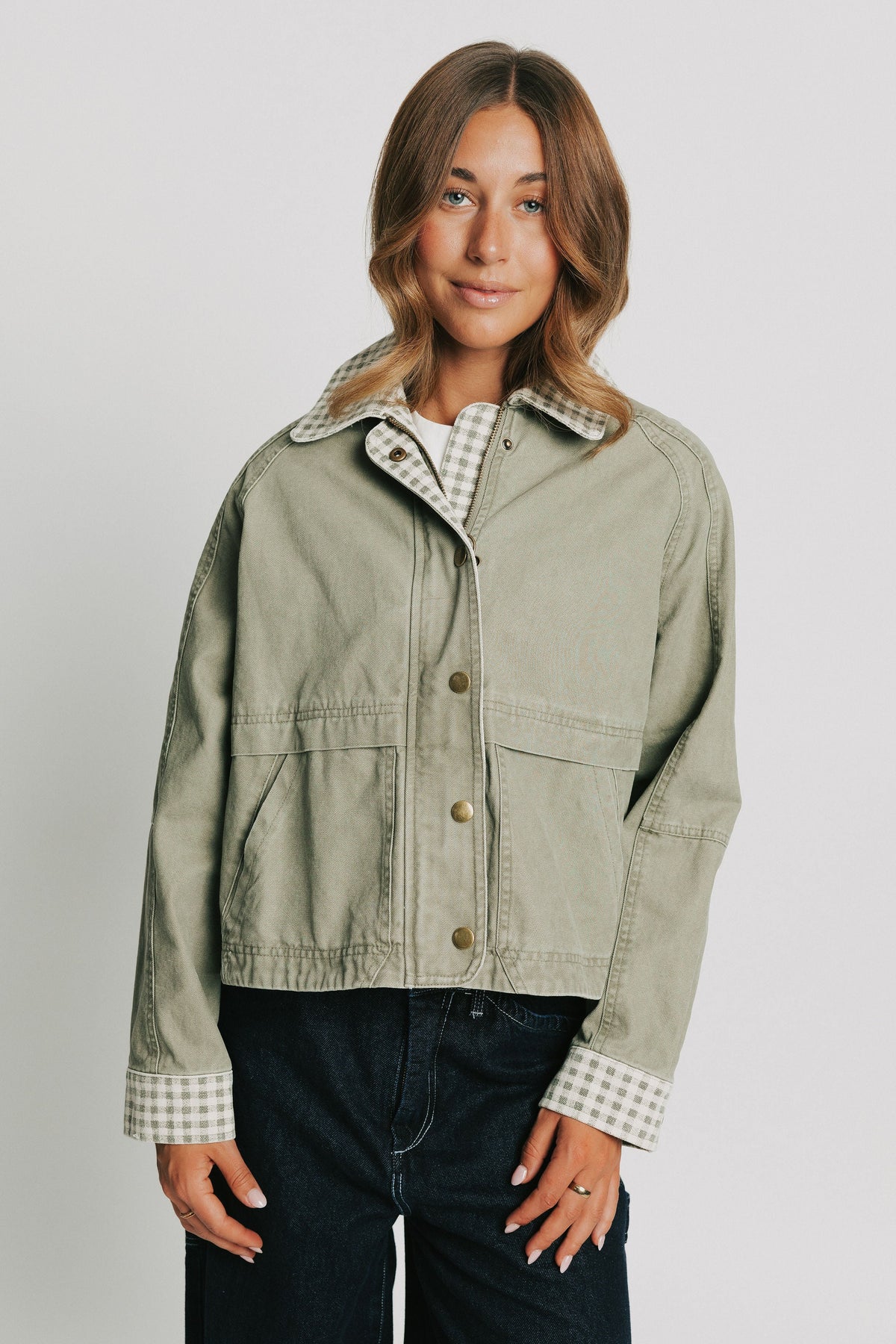 oversized green jacket with checkered print on collar and cuffs front