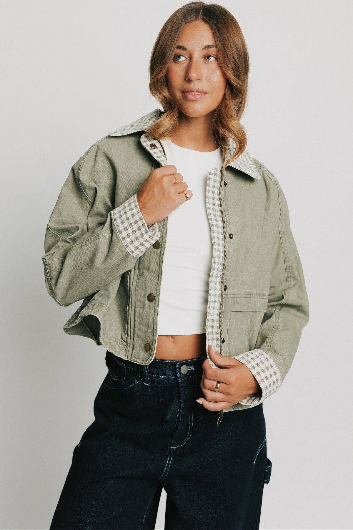 oversized green jacket with checkered print on collar and cuffs
