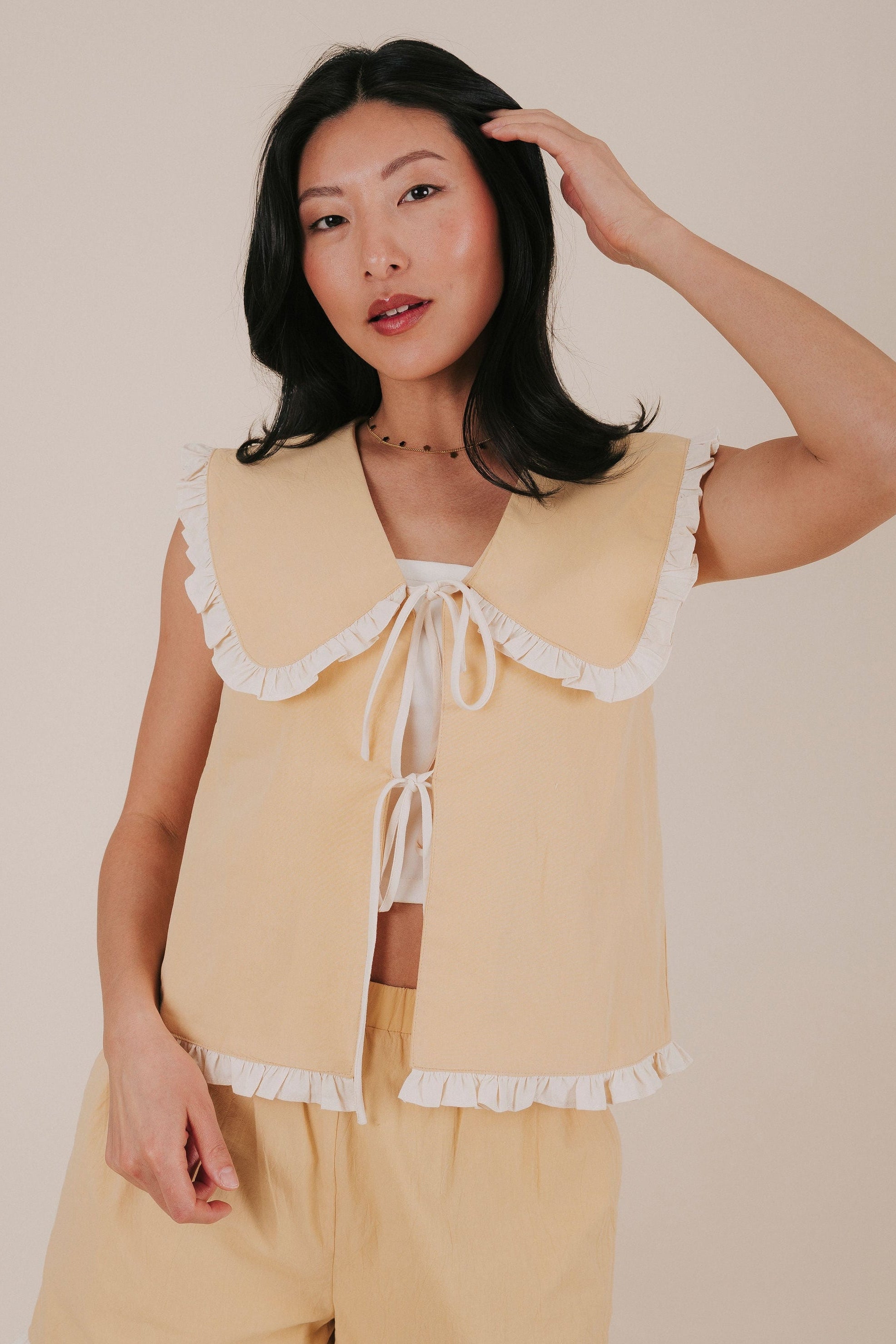 pale yellow ruffle tied ruffle top front