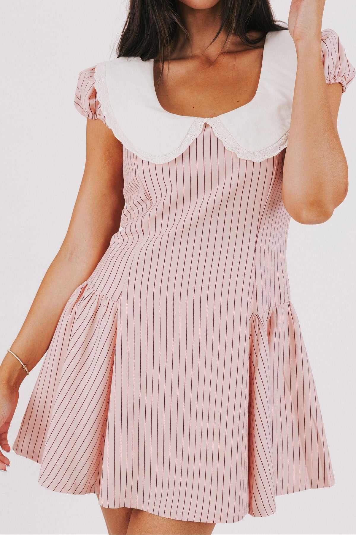 pink striped mini dress with white collar and puff sleeves front