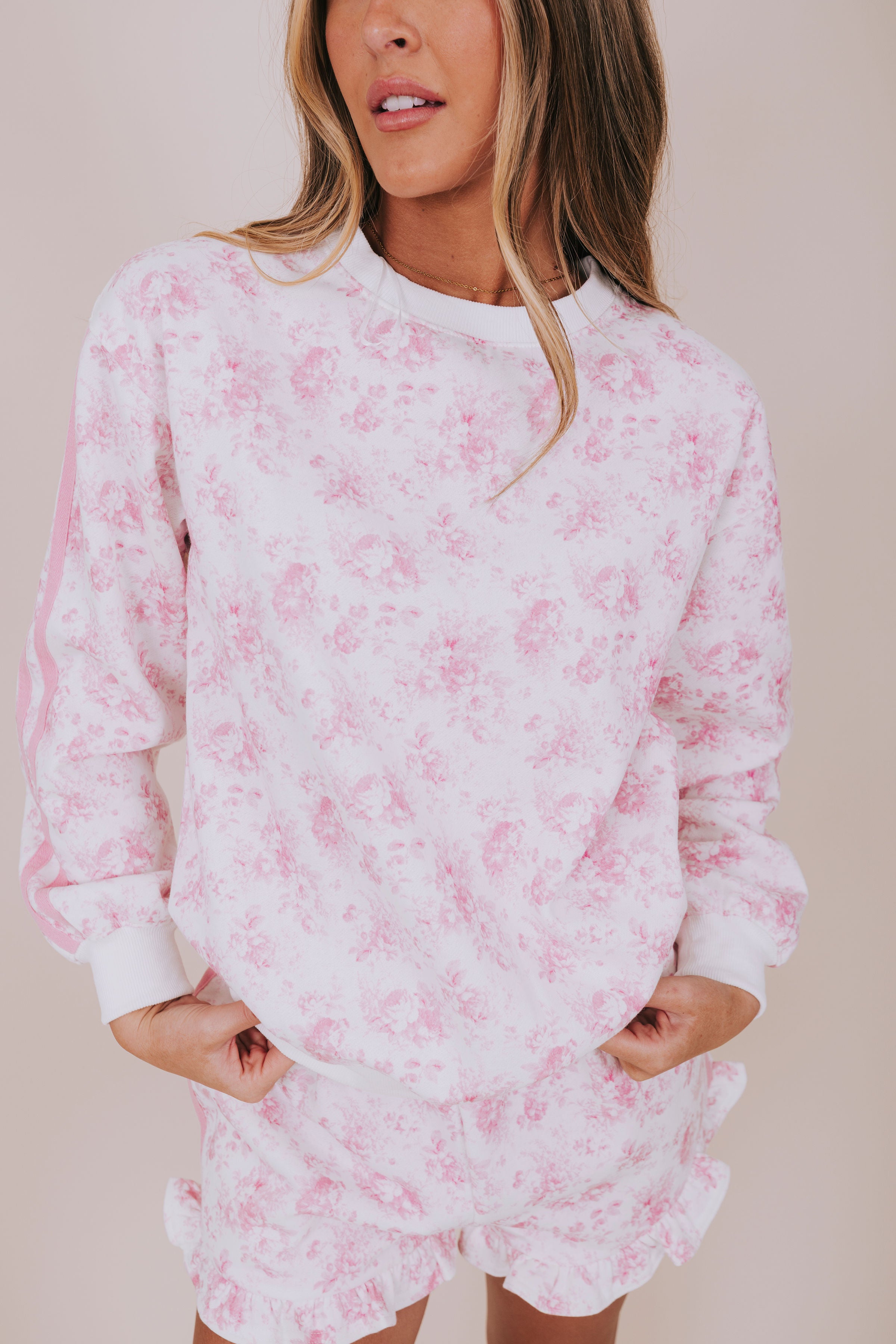 pink floral and white sweatshirt close up