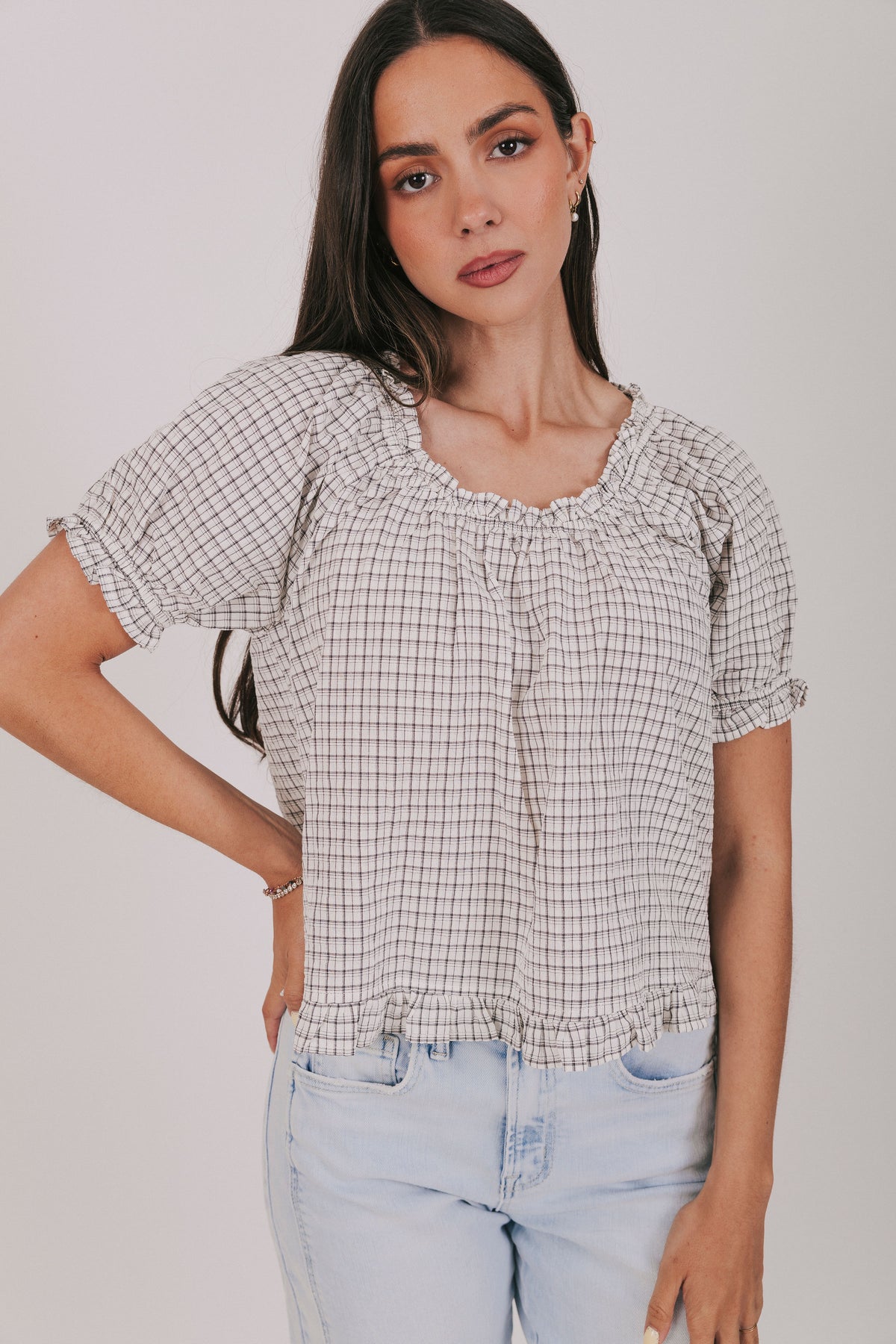 Plaid ruffle trimmed blouse with short puff sleeves and elastic neck