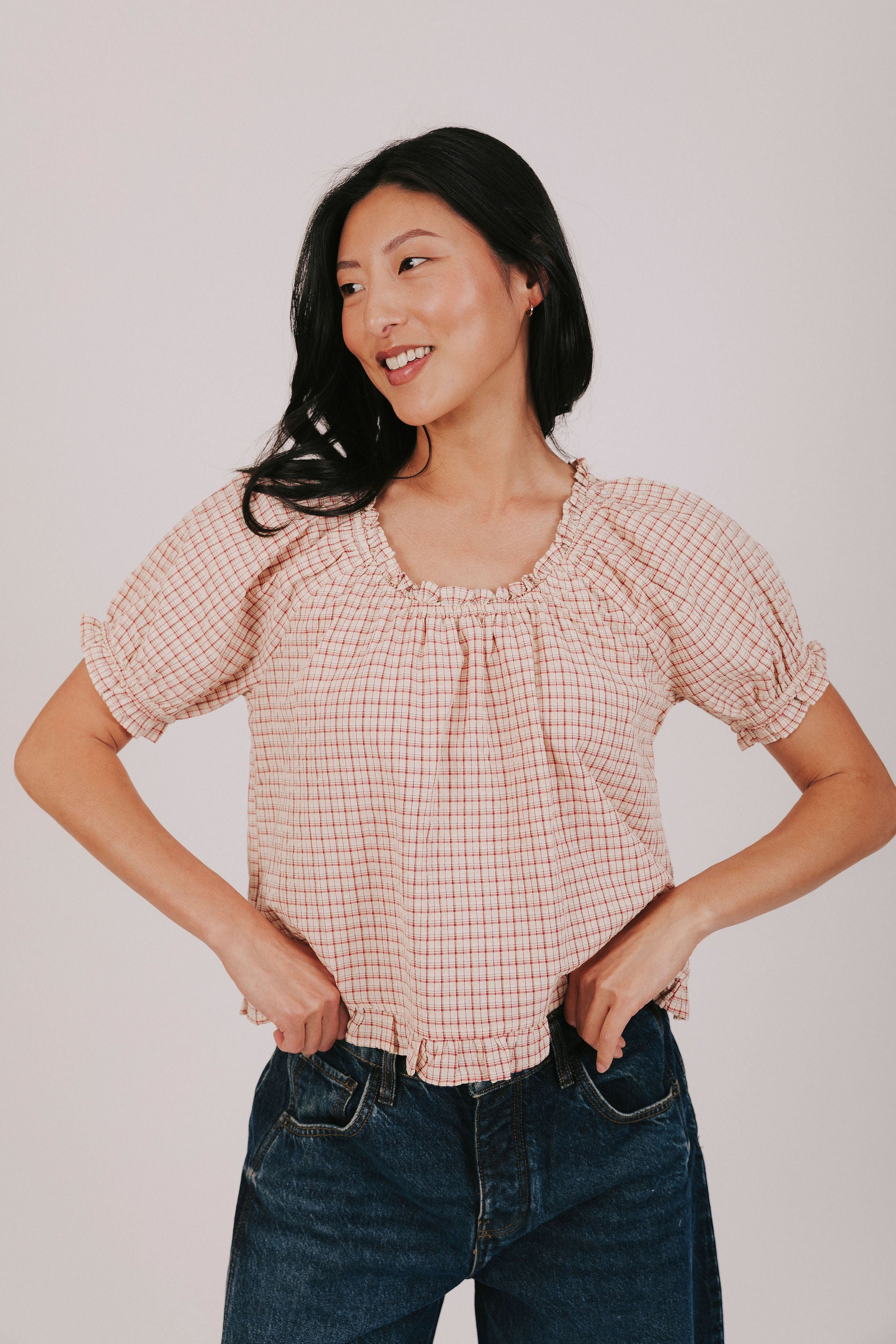 Plaid ruffle trimmed blouse with short puff sleeves and elastic neck