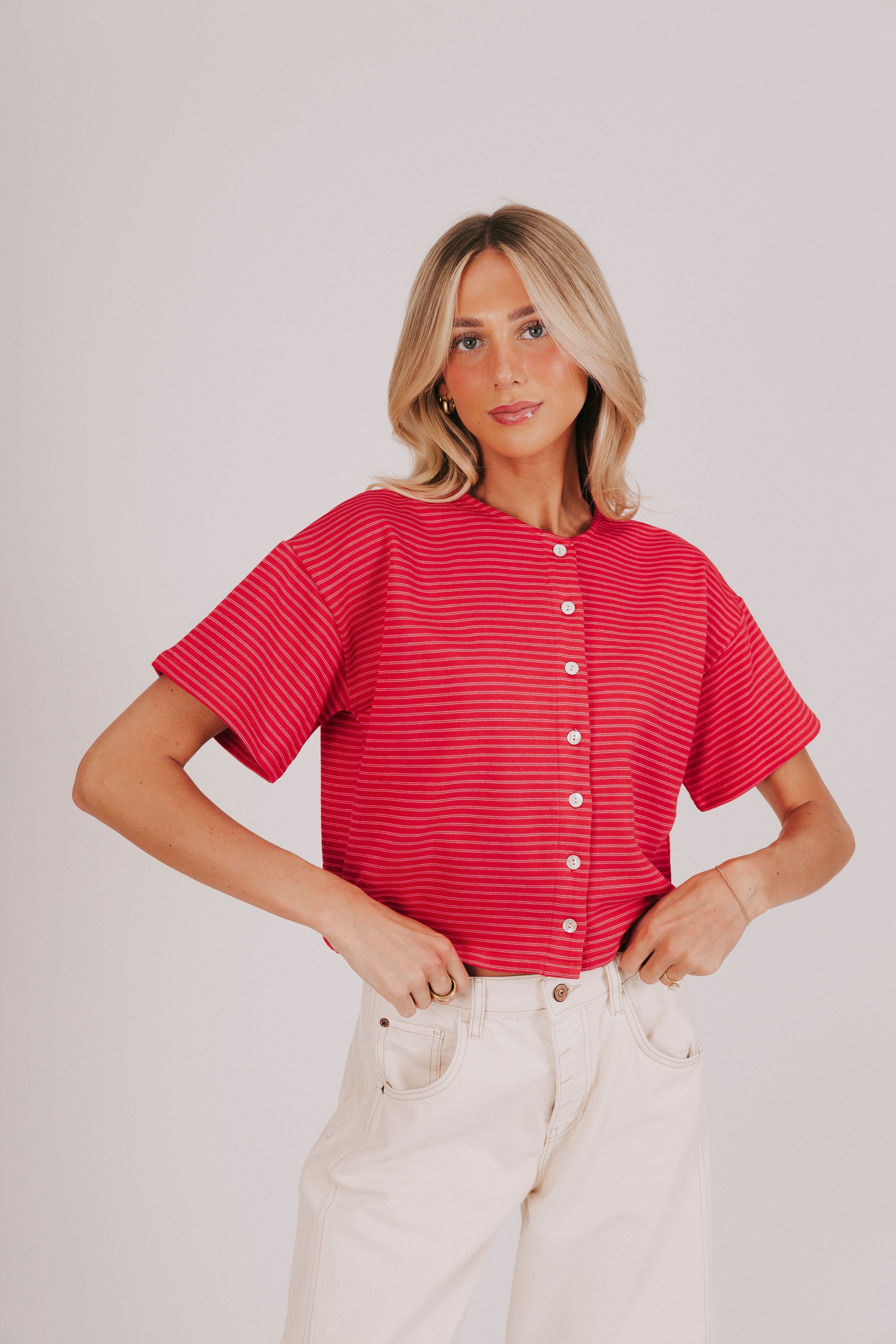 Short sleeved red top with double pink stripes and button down front