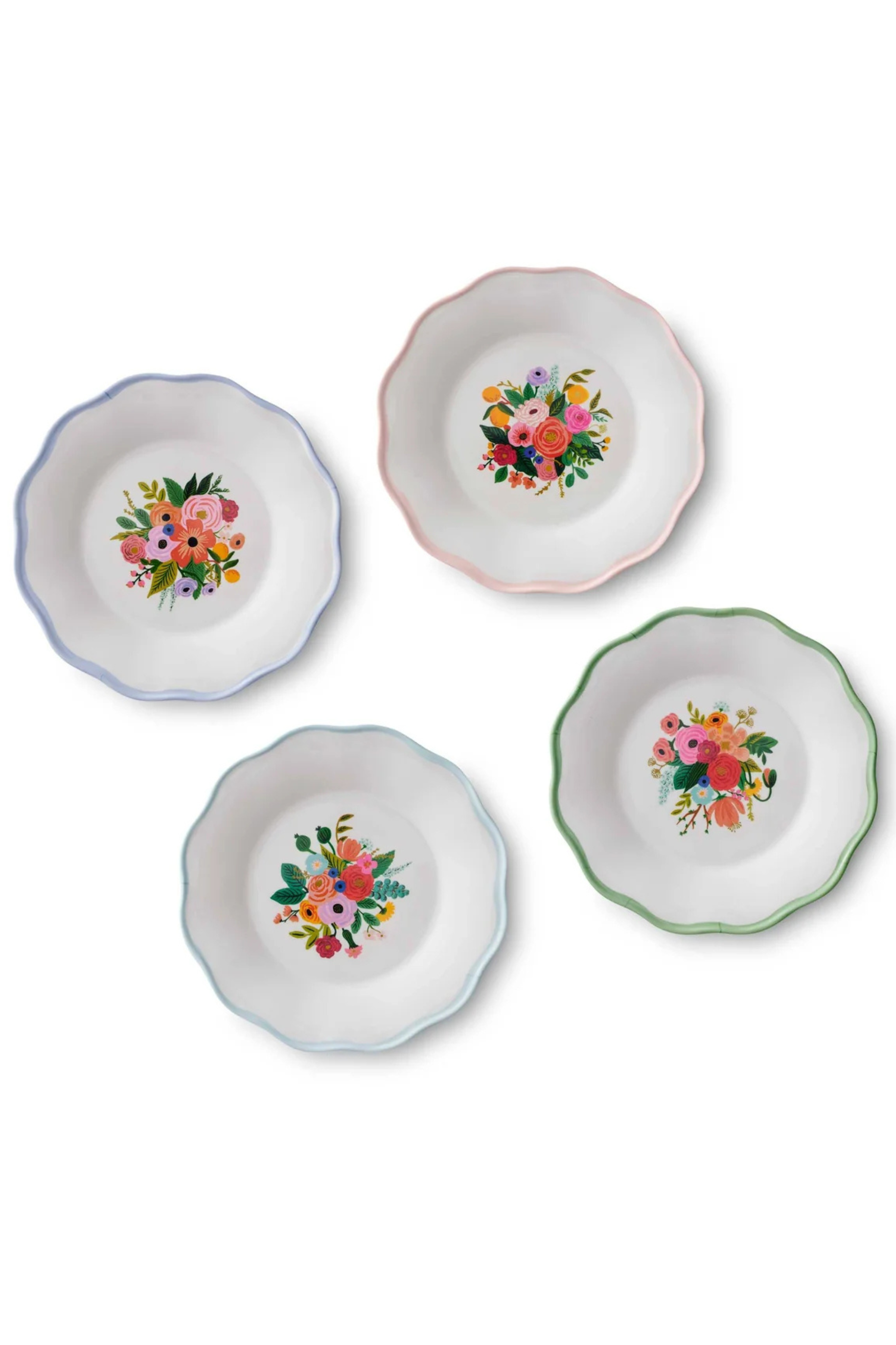Four melamine dessert plates with floral designs on a white background.