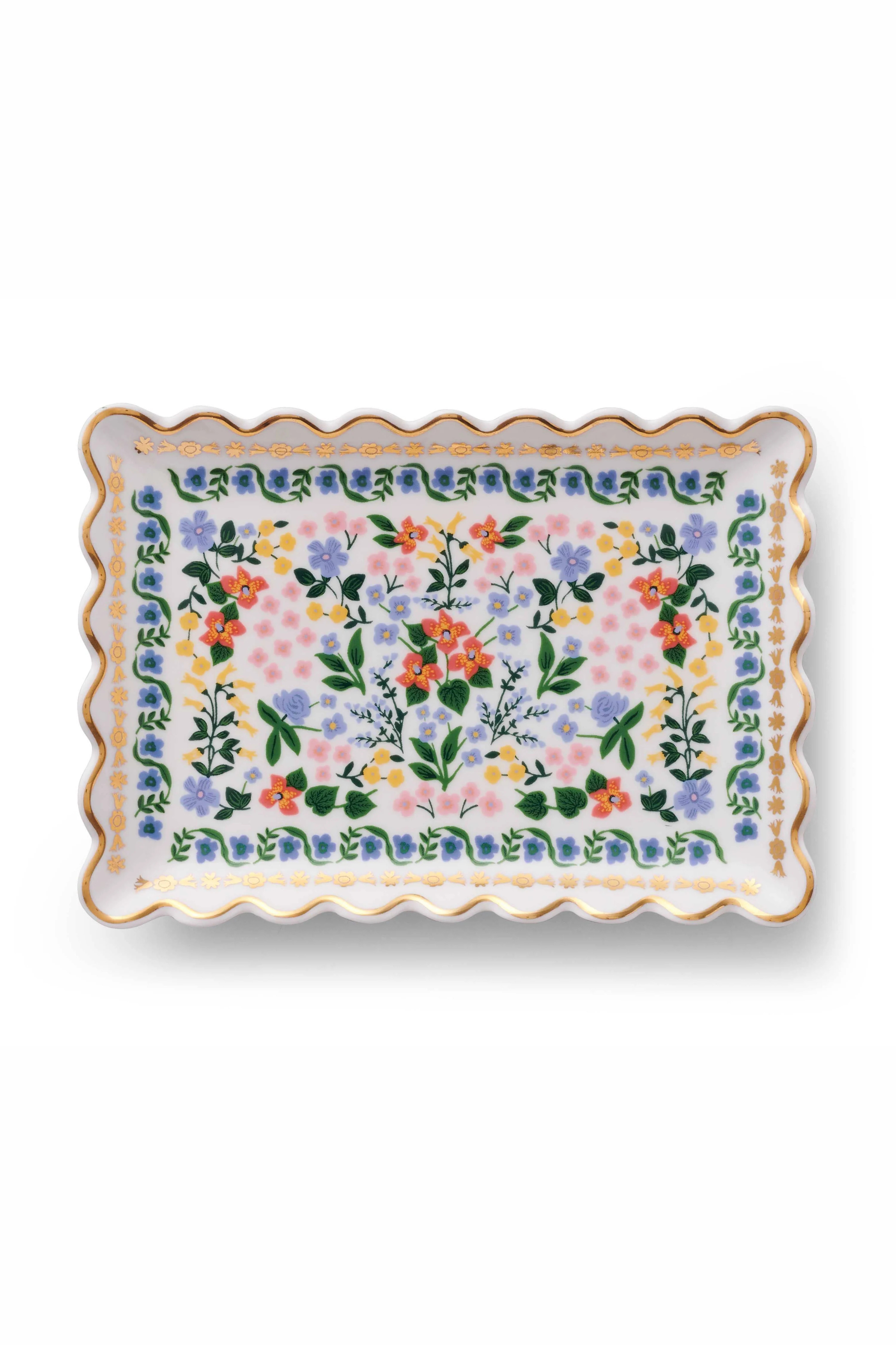 Decorative porcelain tray with a floral pattern and gold details, with a gold lined scalloped edge.