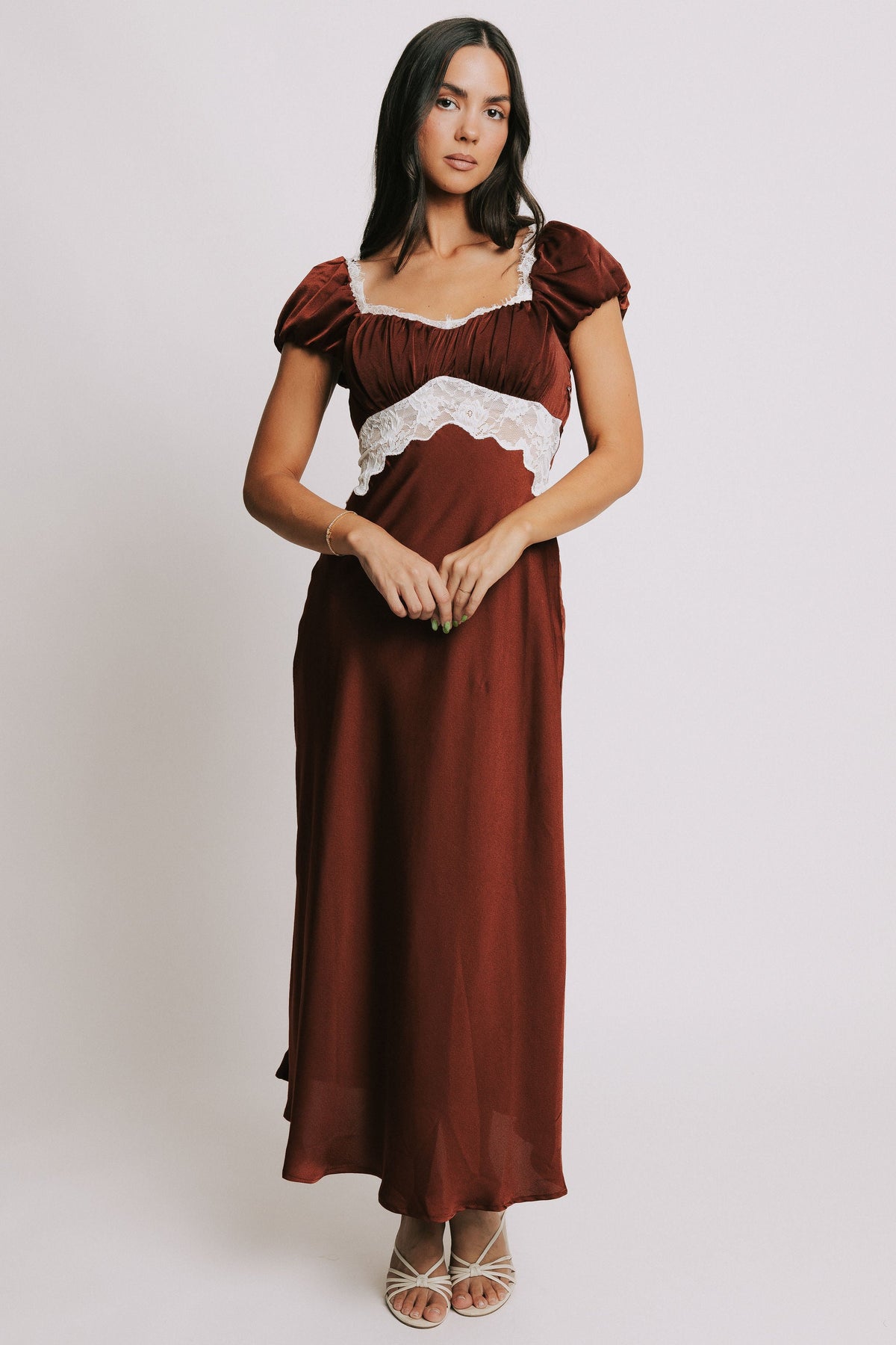 satin dress with puff sleeves and lace cutout on bodice