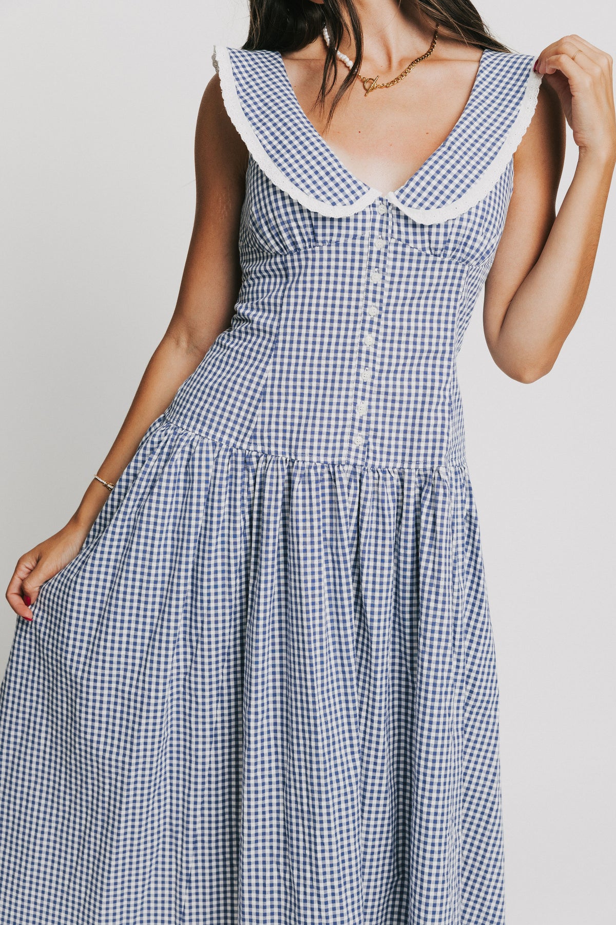 sleeveless blue and white gingham drop waist dress with collar
