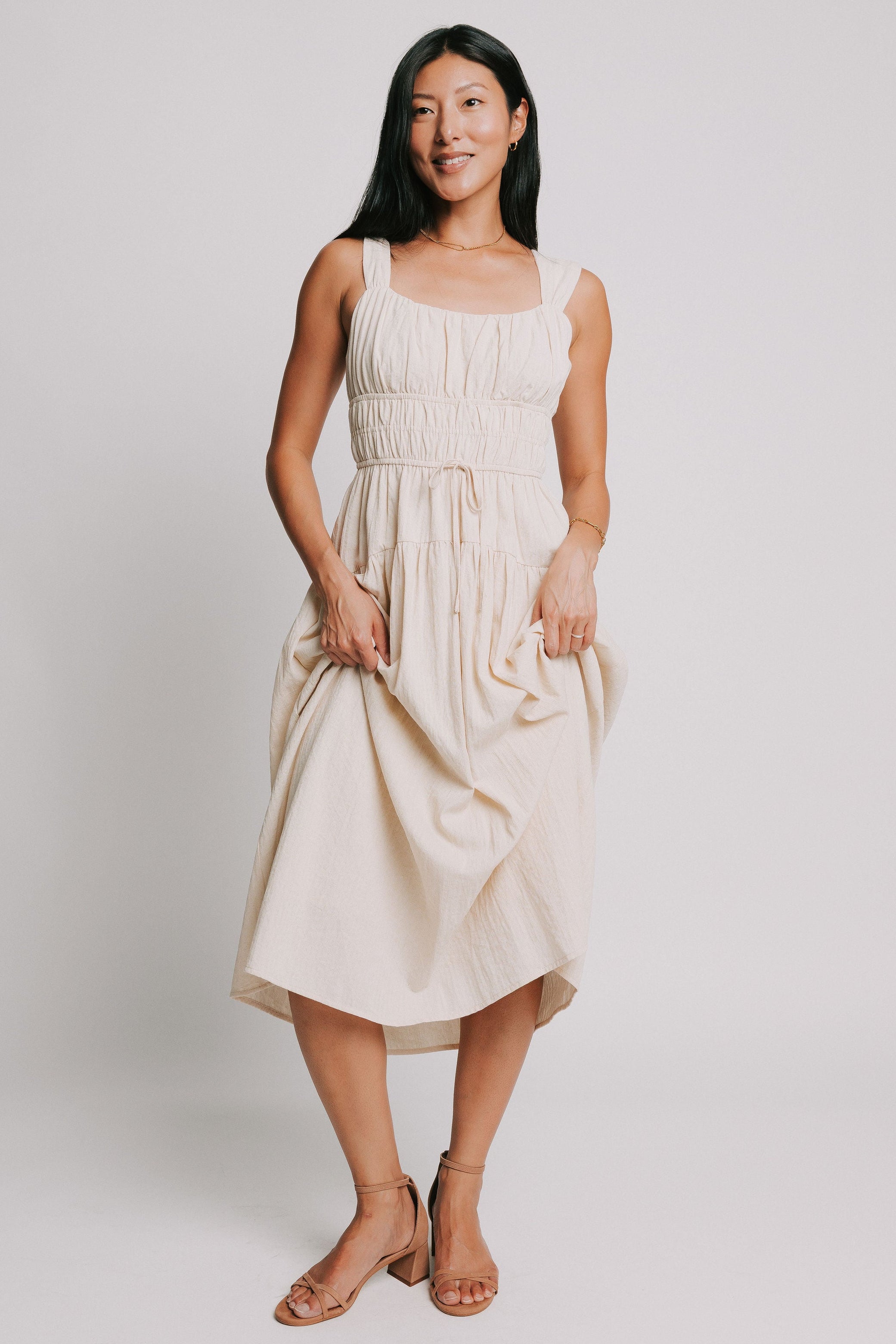 sleeveless cream midi dress with gathered bodice