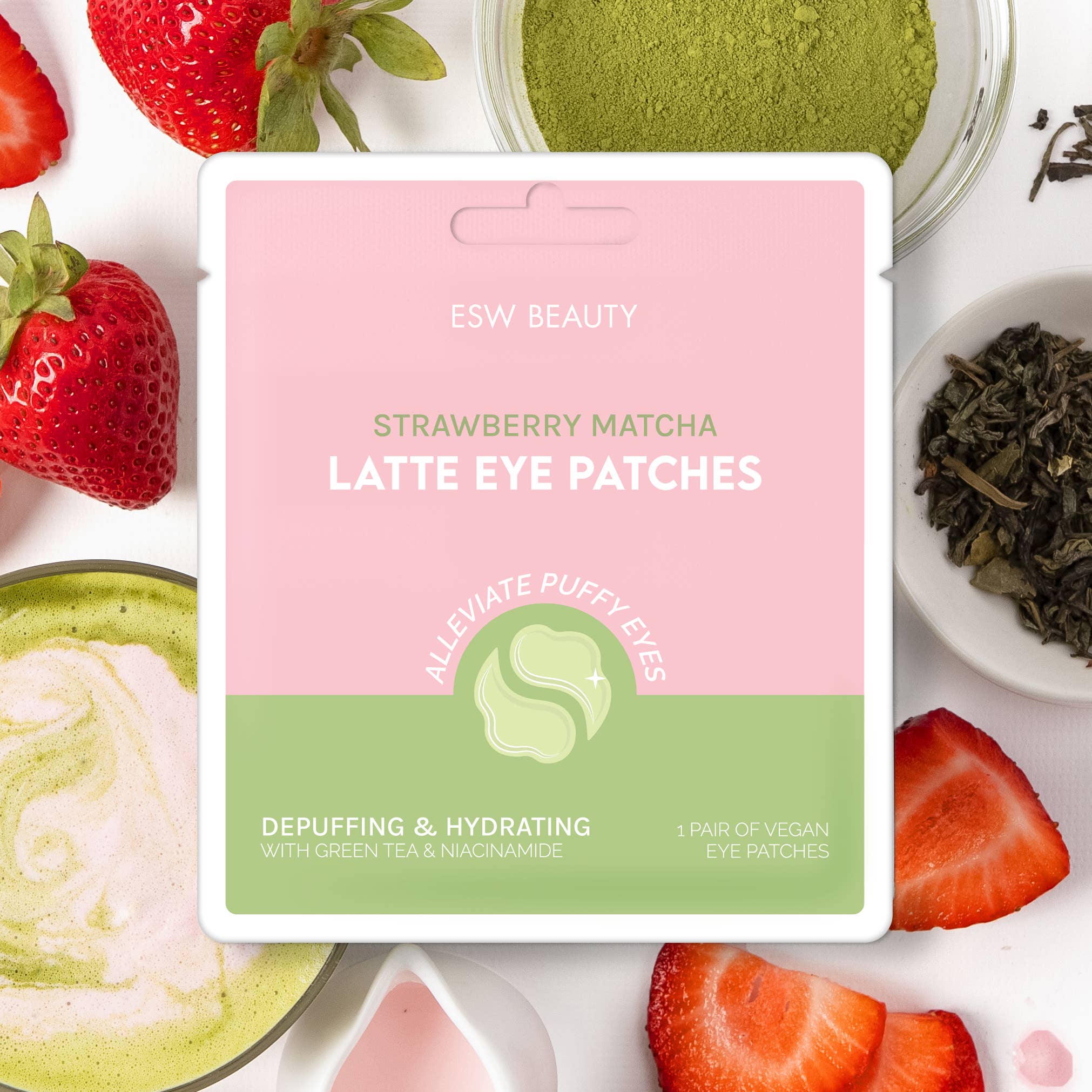 Packaging of Strawberry Matcha Latte Depuffing & Hydrating Eye Patches by ESW Beauty, with strawberries and matcha powder around it.
