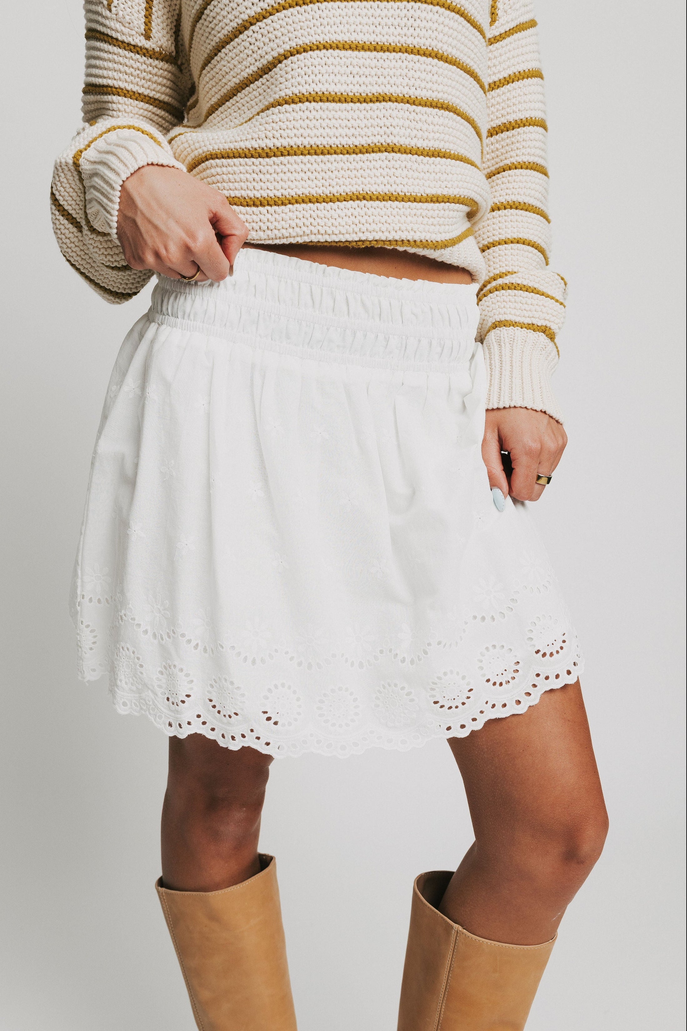 white mini skirt with eyelet on hemline