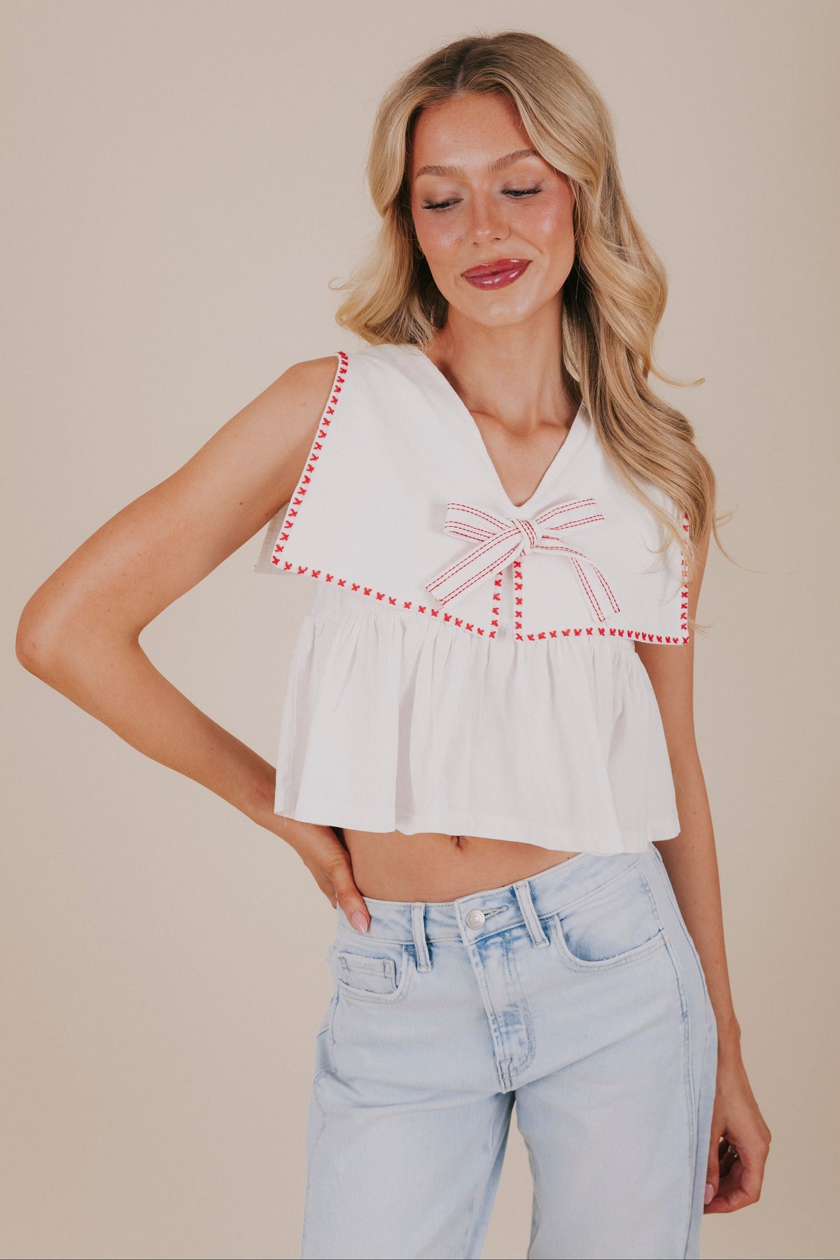 white oversized collared top with red stitching front