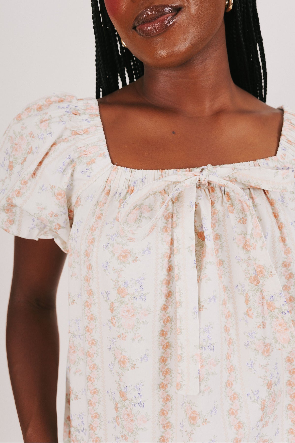 white puff sleeve top with floral pattern and bow