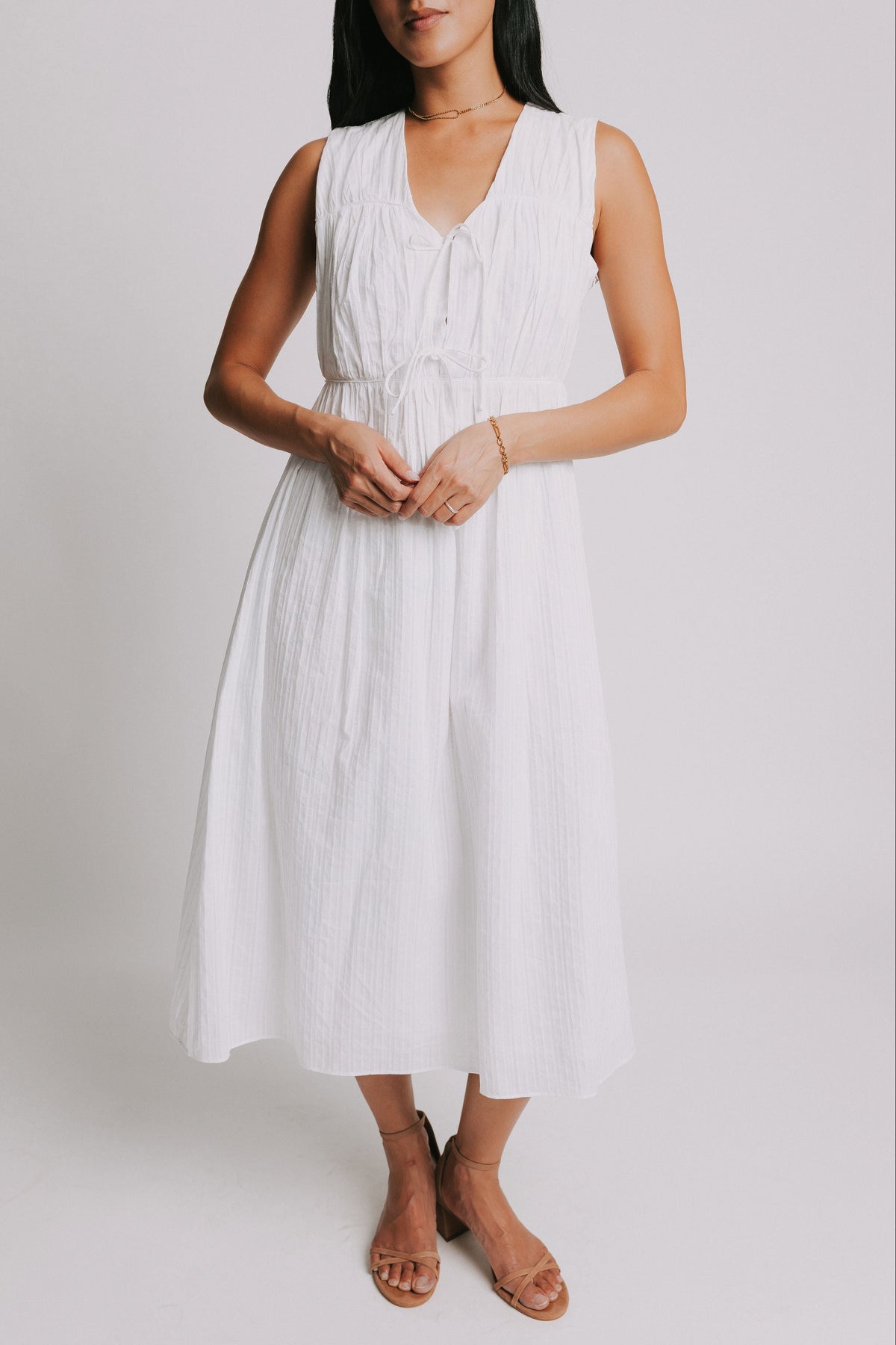 white sleeveless midi dress with bows on bodice