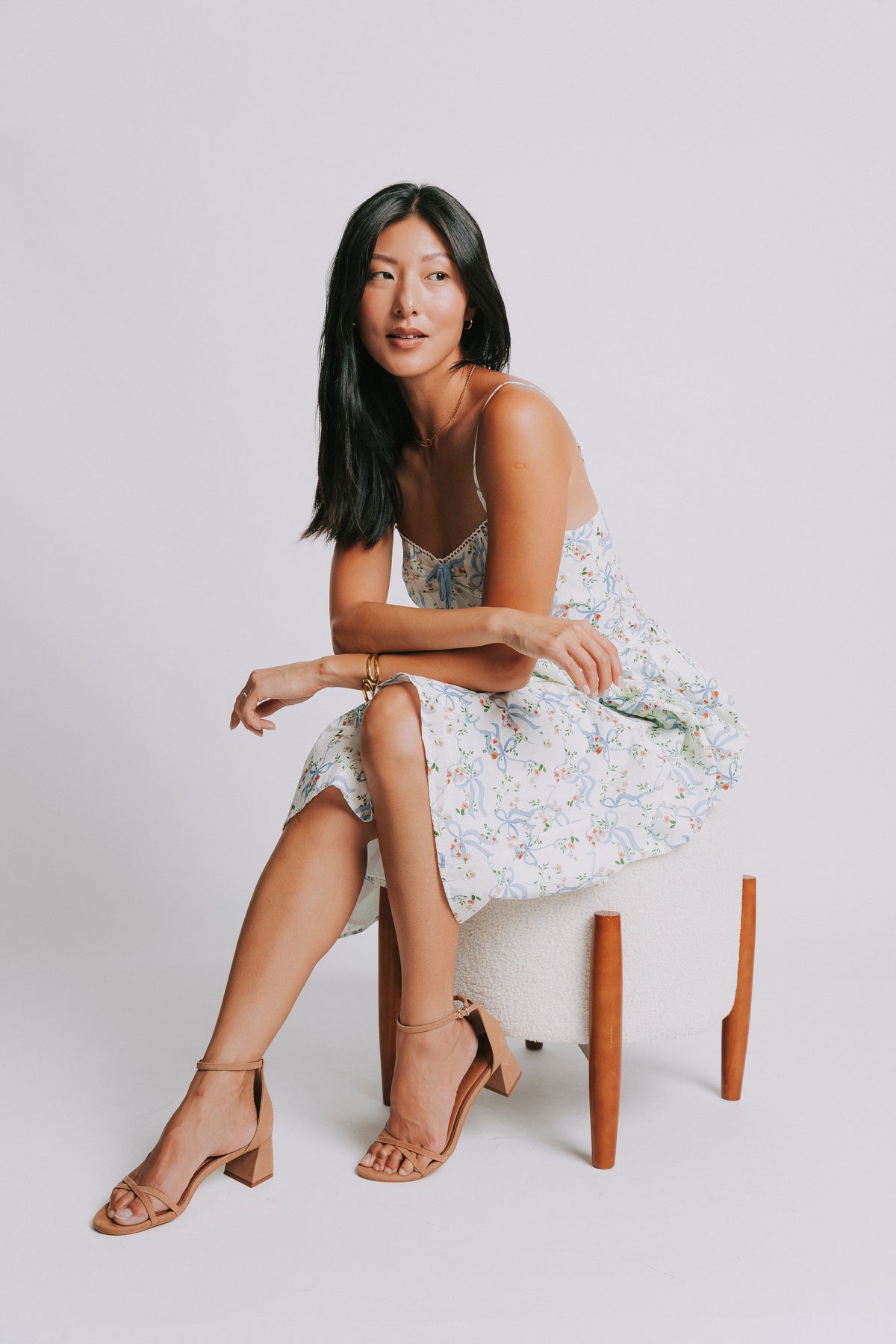 white spaghetti strap midi dress with blue bow pattern pose