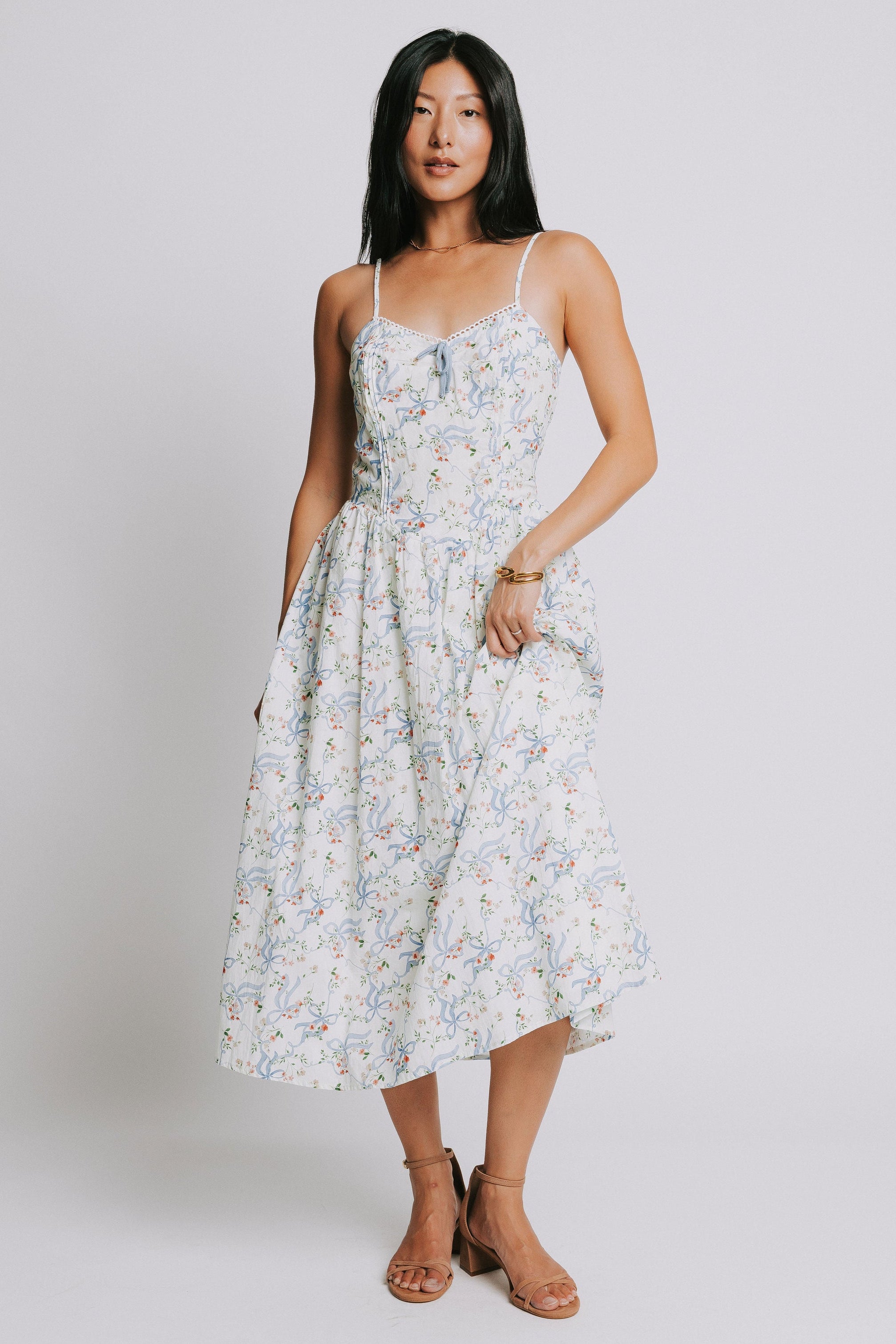 white spaghetti strap midi dress with blue bow pattern